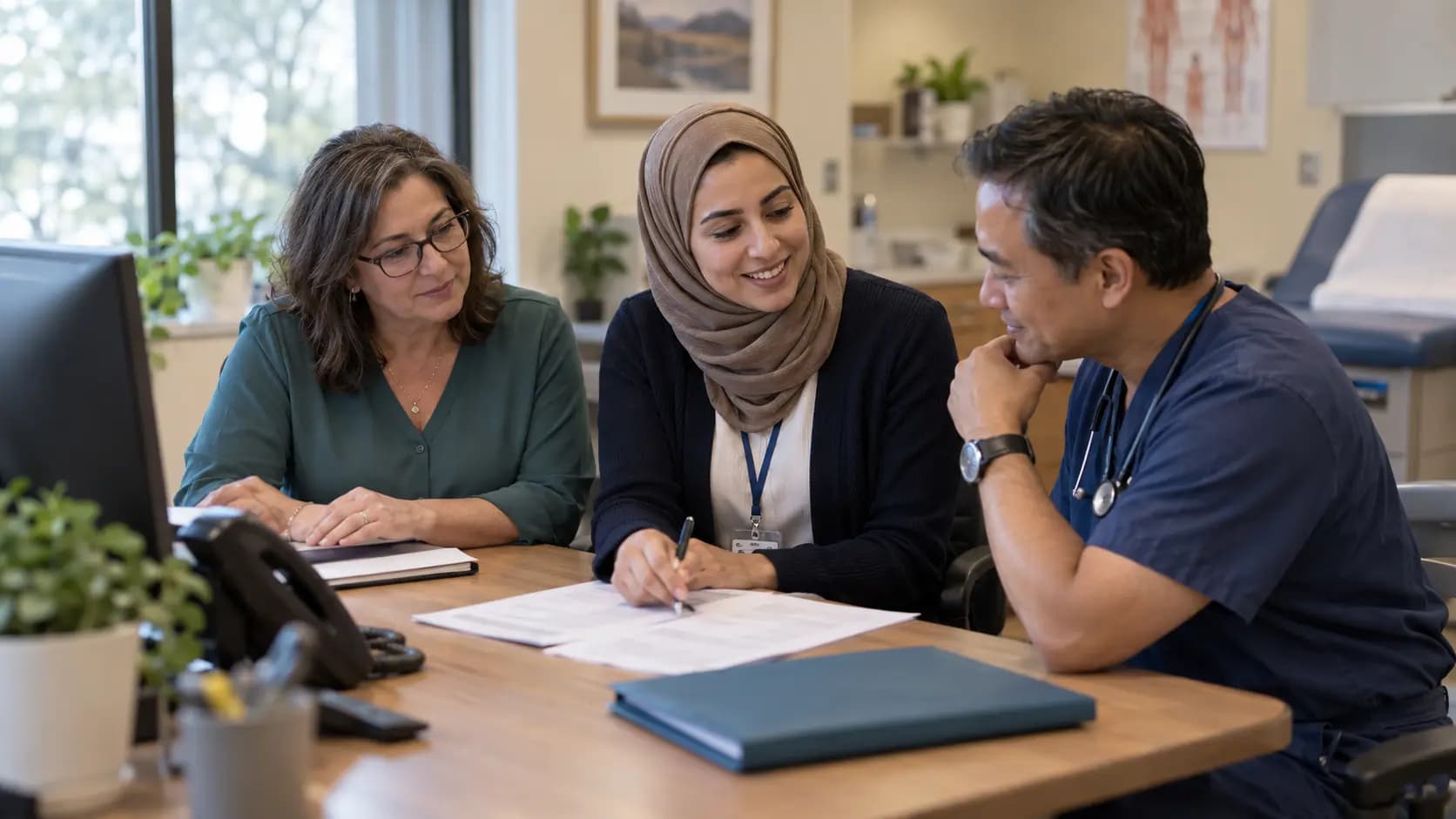 Practice manager and clinician reviewing payer requirements with a specialist