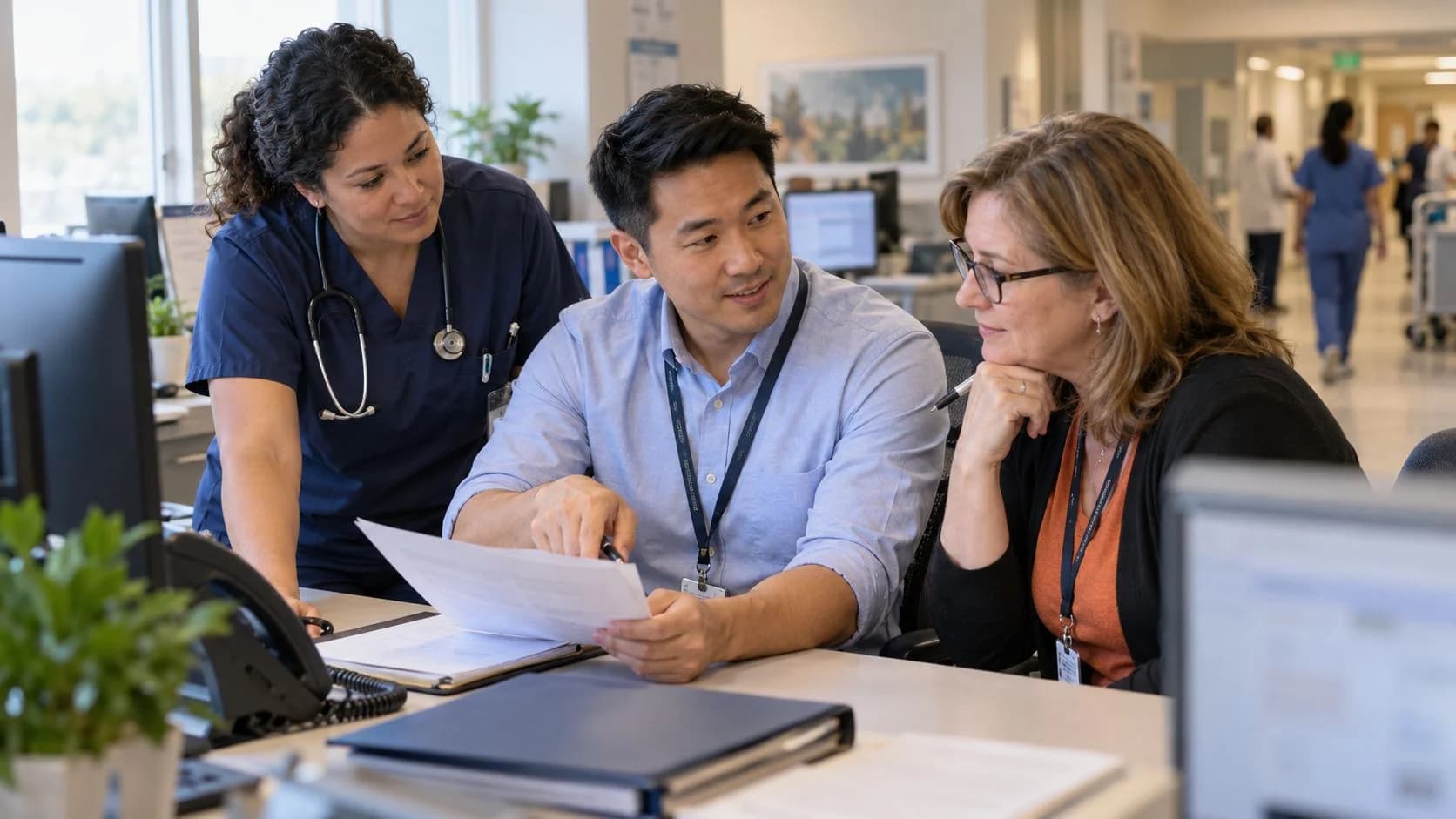 Denial-resolution specialist and clinician reviewing a claim together