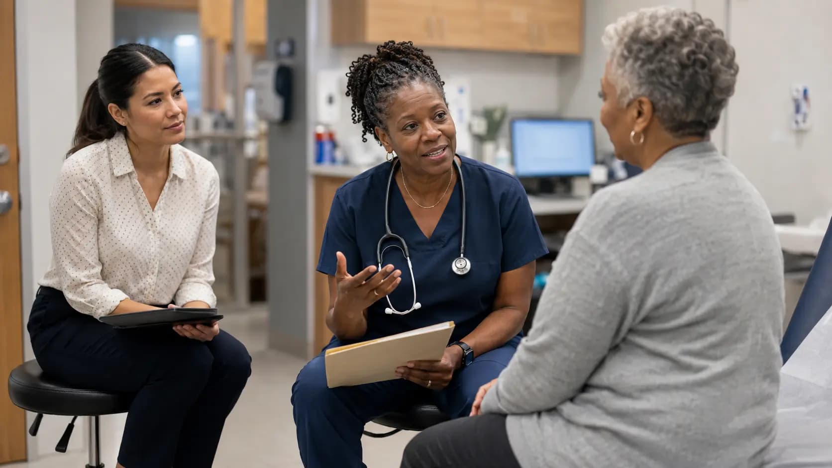 Clinician, patient, and healthcare colleague sharing a warm clinic interaction
