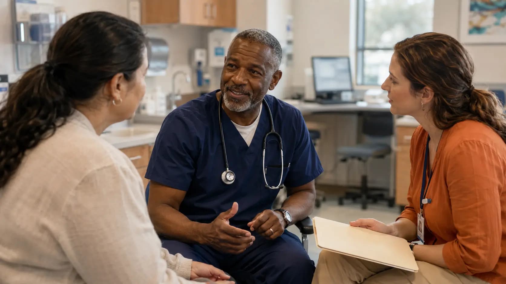 Clinician, patient, and healthcare colleague sharing a warm clinic interaction