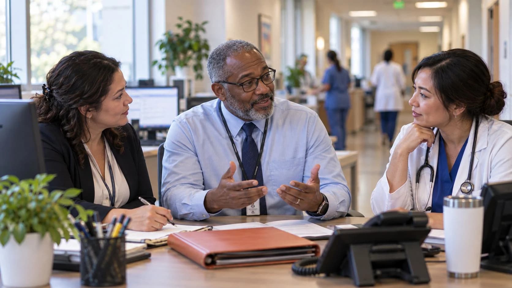 Denial-resolution specialist and clinician reviewing a claim together