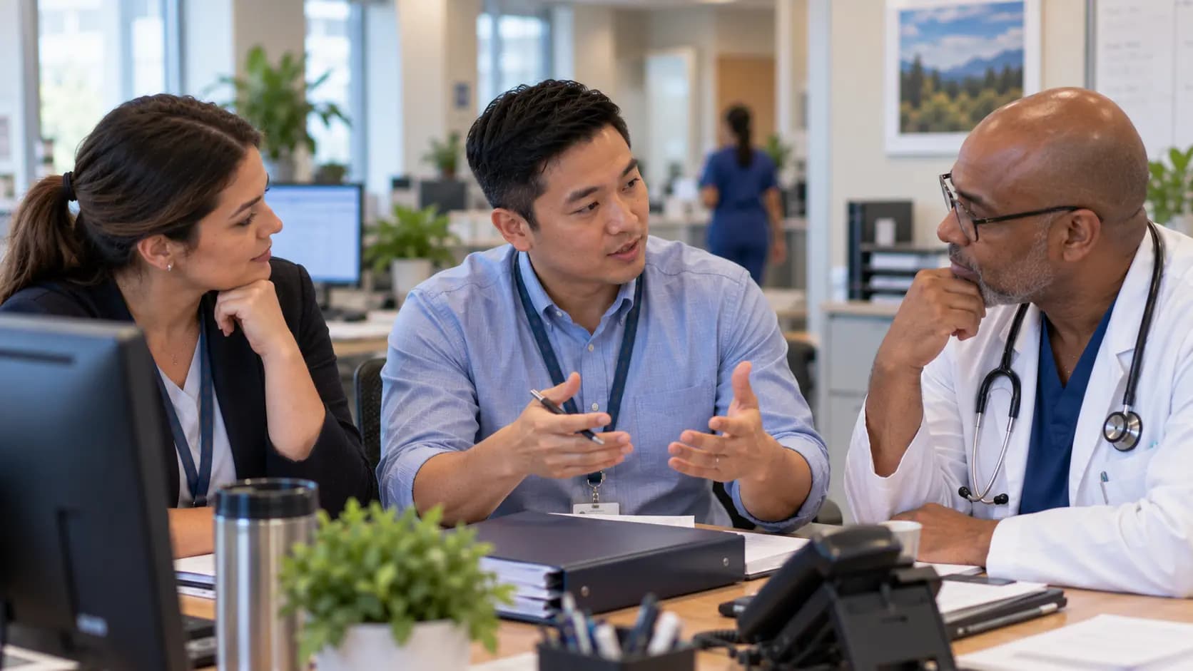 Practice manager and clinician reviewing payer requirements with a specialist