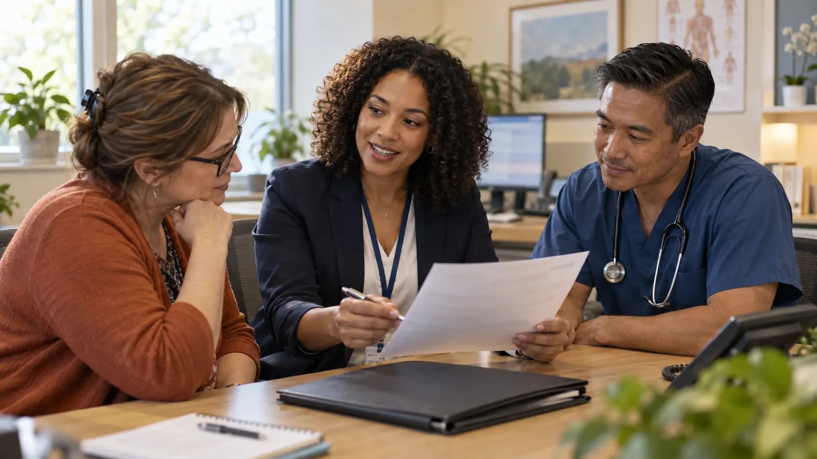 Practice manager and clinician reviewing payer requirements with a specialist