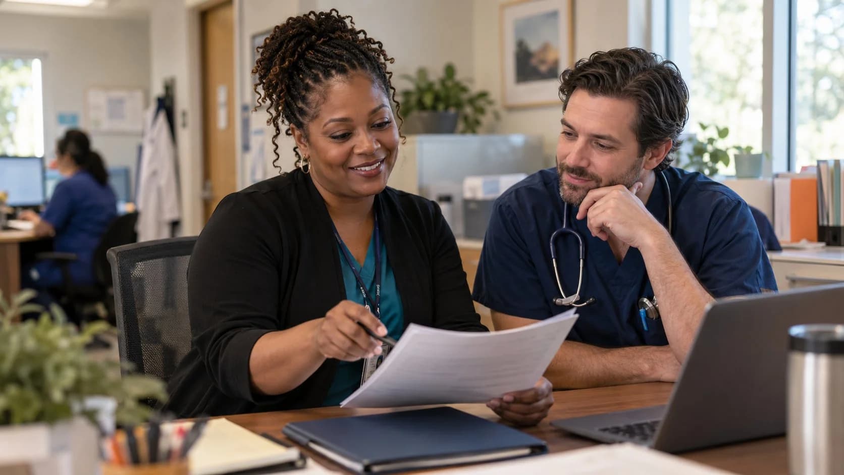 Denial specialist and clinician reviewing a claim workflow together