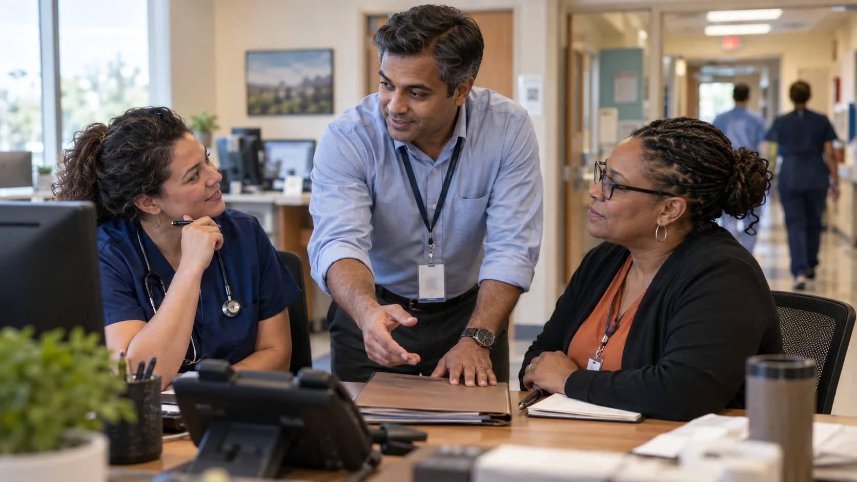 Denial-resolution specialist and clinician reviewing a claim together