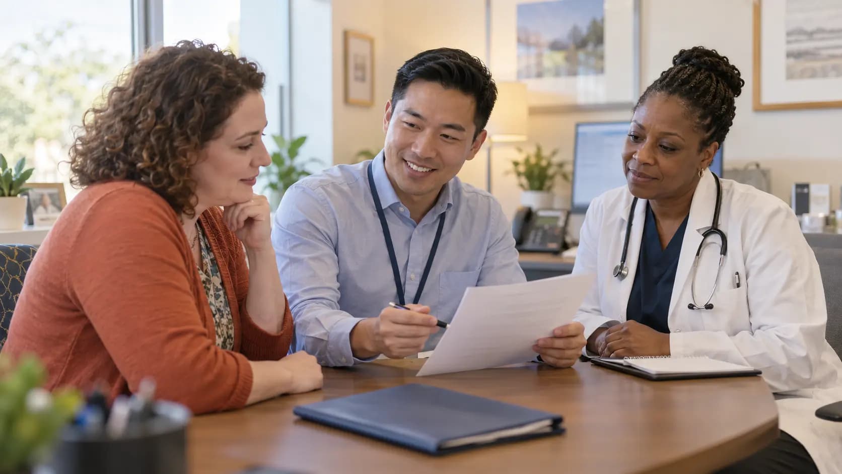 Practice manager and clinician reviewing payer requirements with a specialist