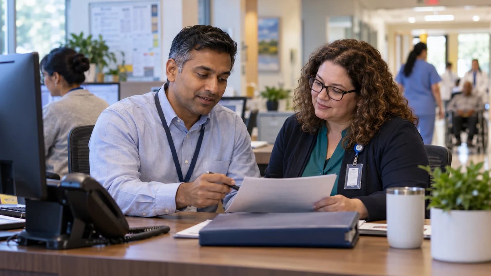 Reimbursement analyst and revenue manager reviewing a payment variance