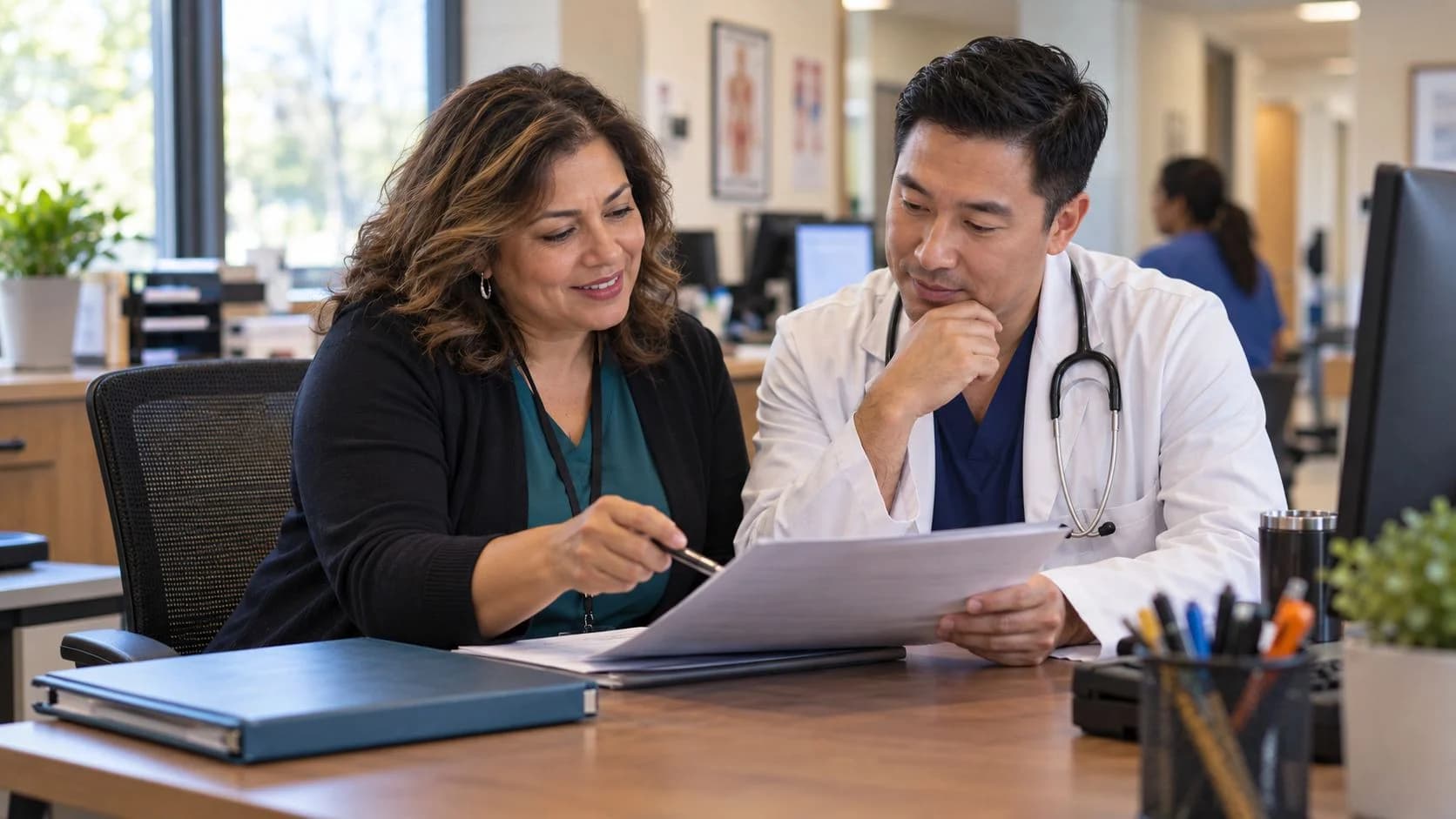 Medical coder and clinician discussing documentation in a medical office