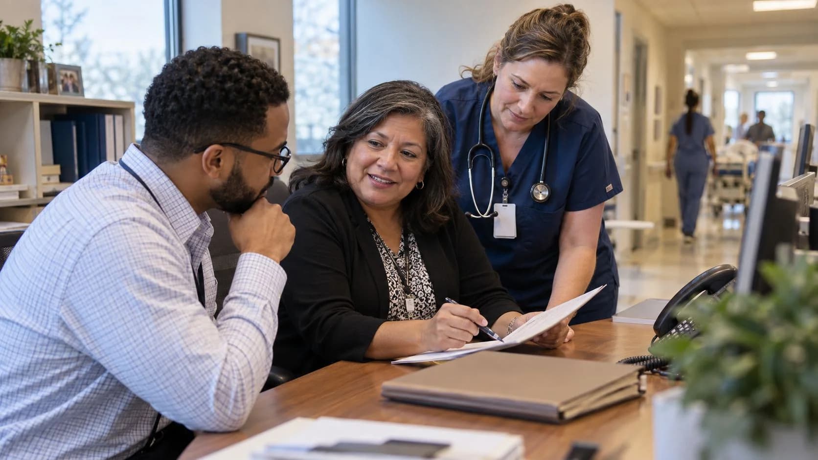Denial-resolution specialist and clinician reviewing a claim together