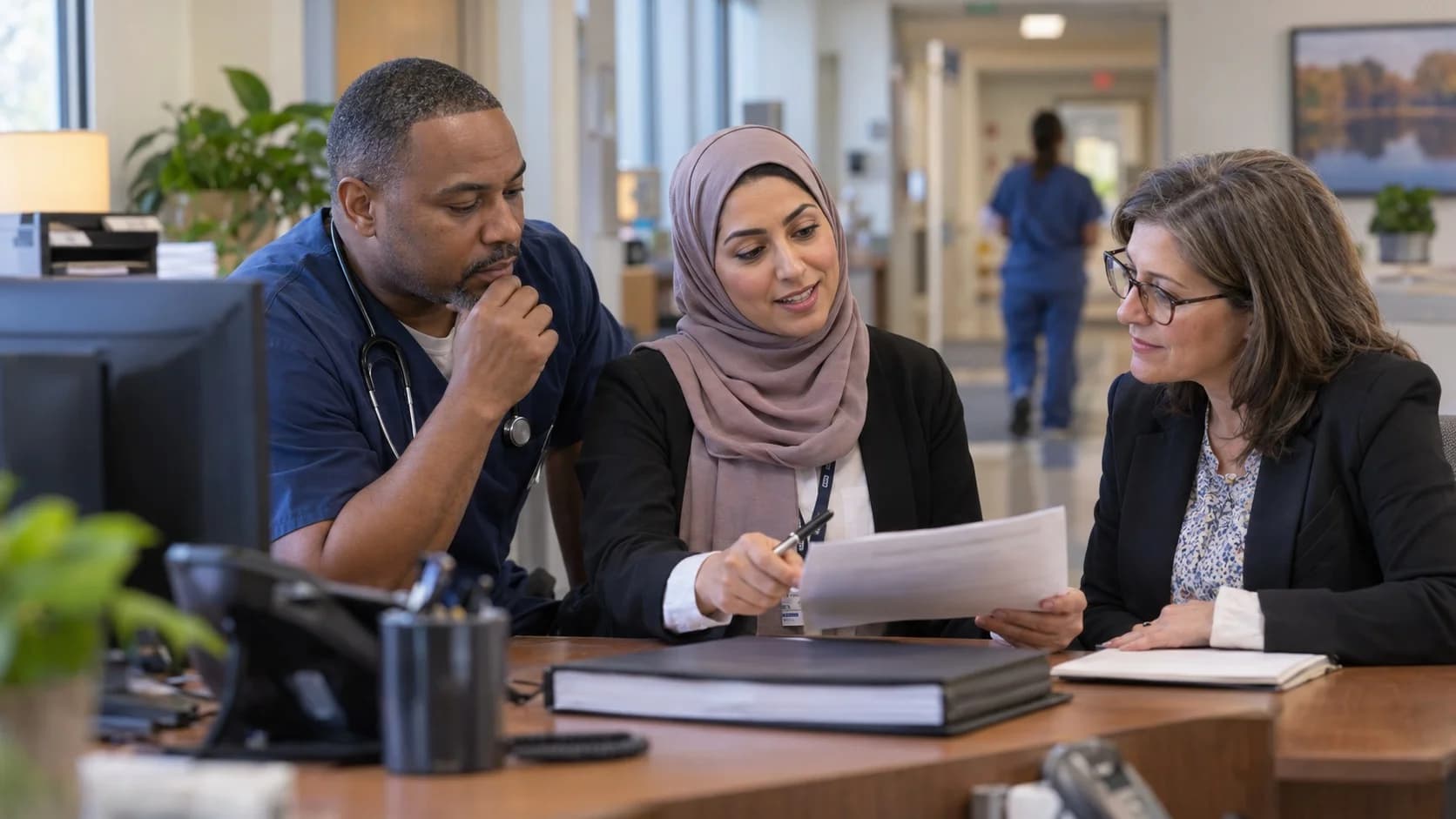 Denial-resolution specialist and clinician reviewing a claim together