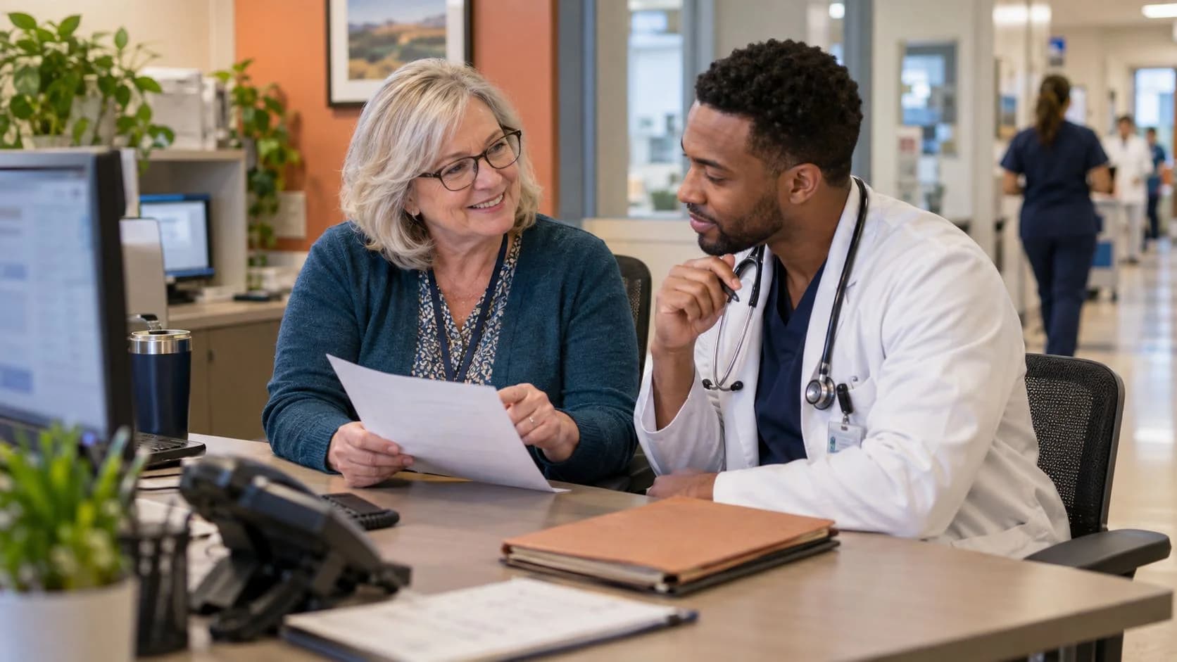 Medical coder and clinician resolving a claim detail together