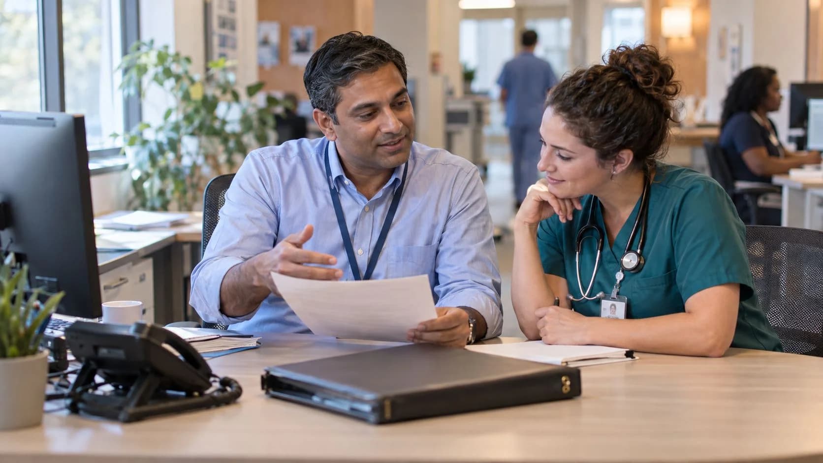 Medical coder and clinician resolving a claim detail together
