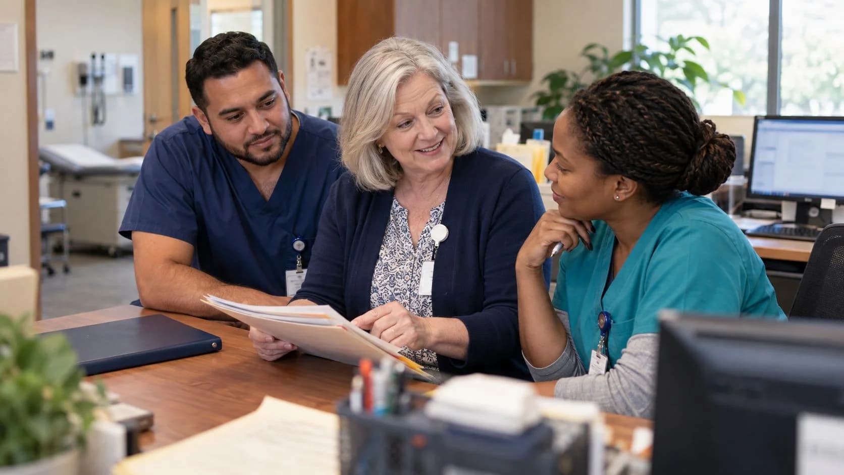 Revenue-cycle educator discussing a workflow with medical-office colleagues