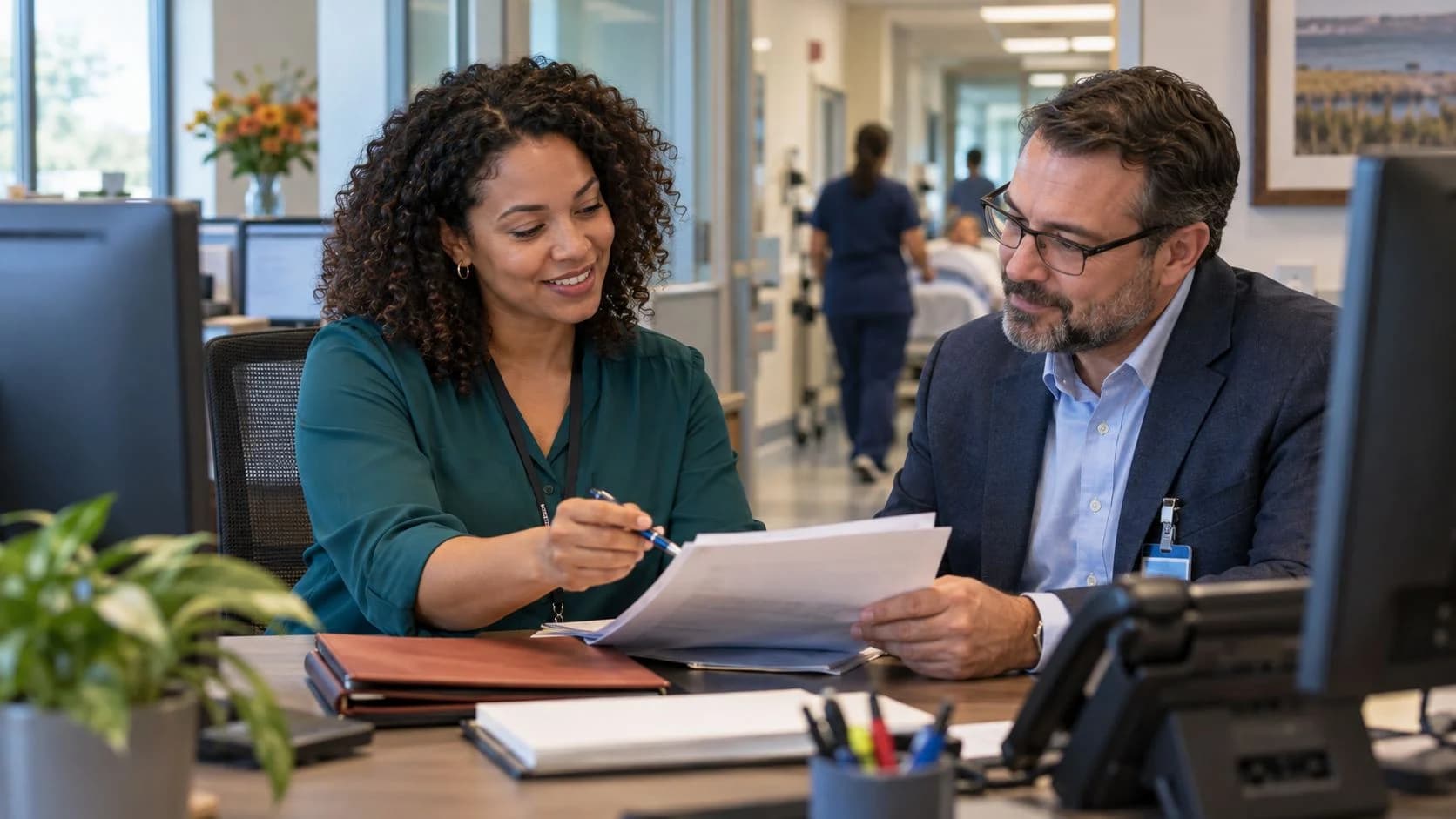 Reimbursement analyst and revenue manager reviewing a payment variance