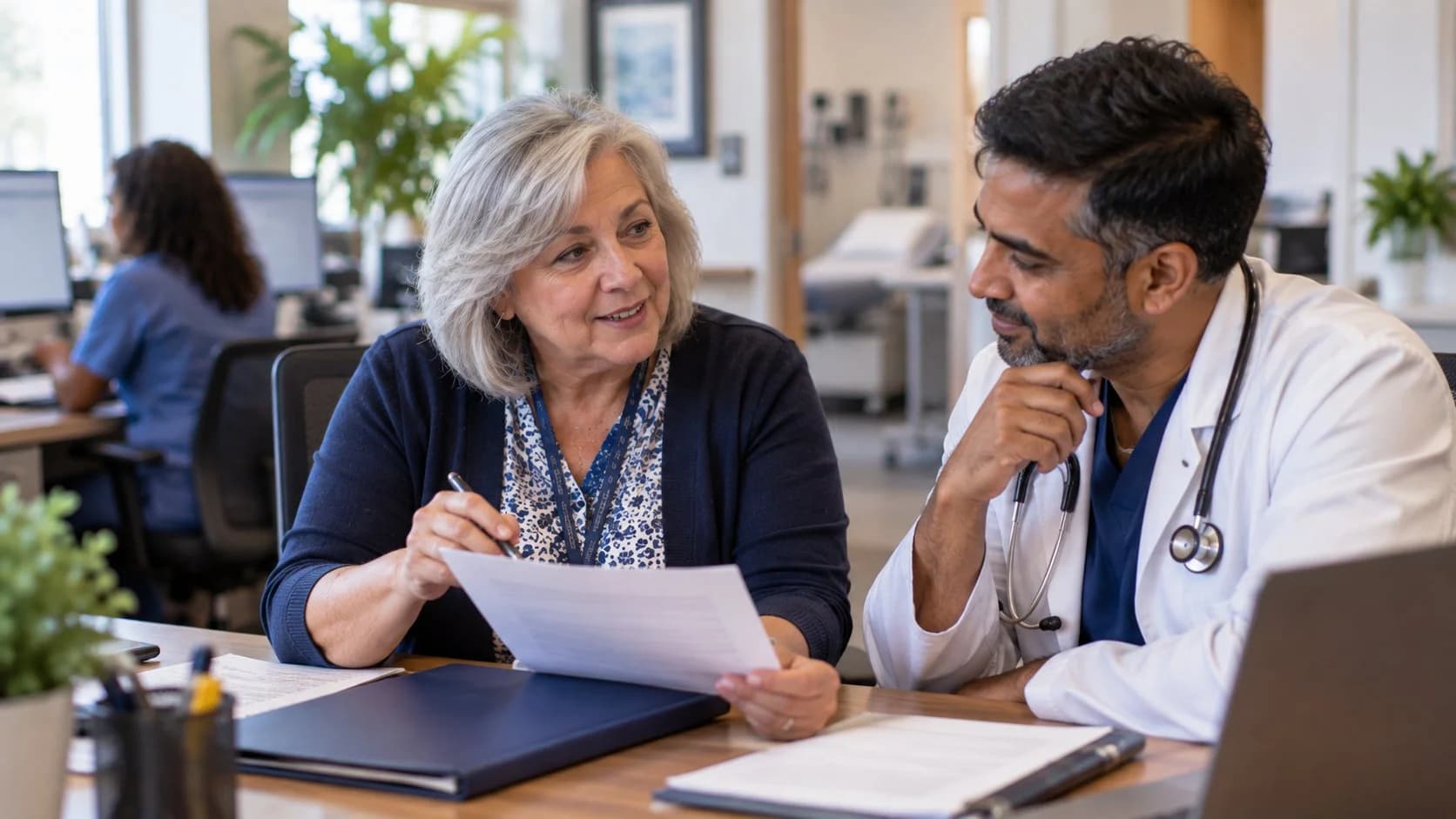 Medical coder and clinician discussing documentation in a medical office