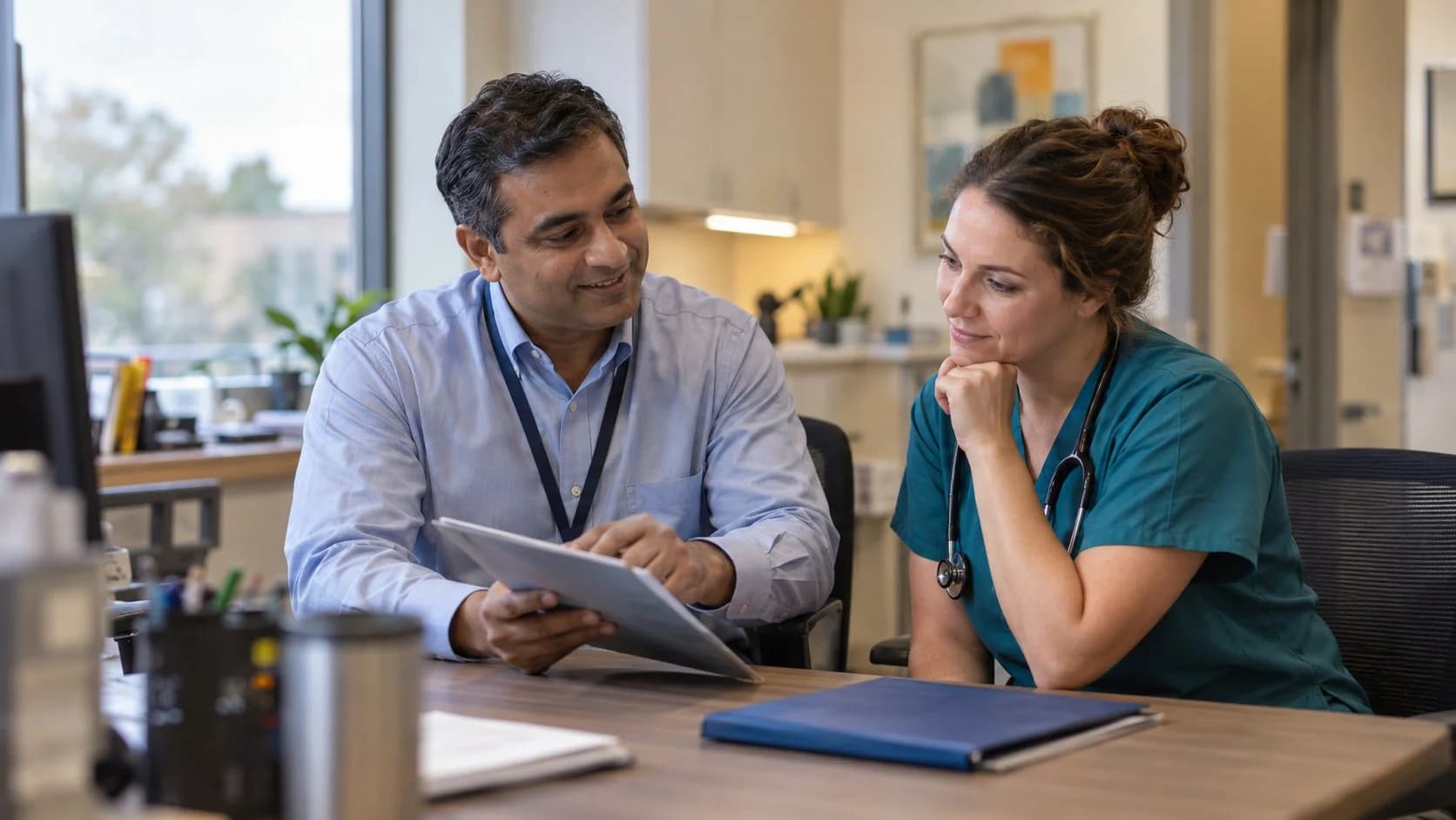 Denial specialist and clinician reviewing a claim workflow together