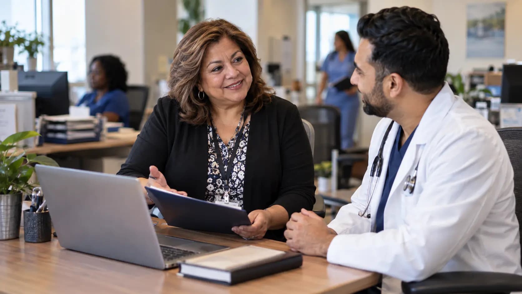 Credentialing coordinator helping a clinician with onboarding