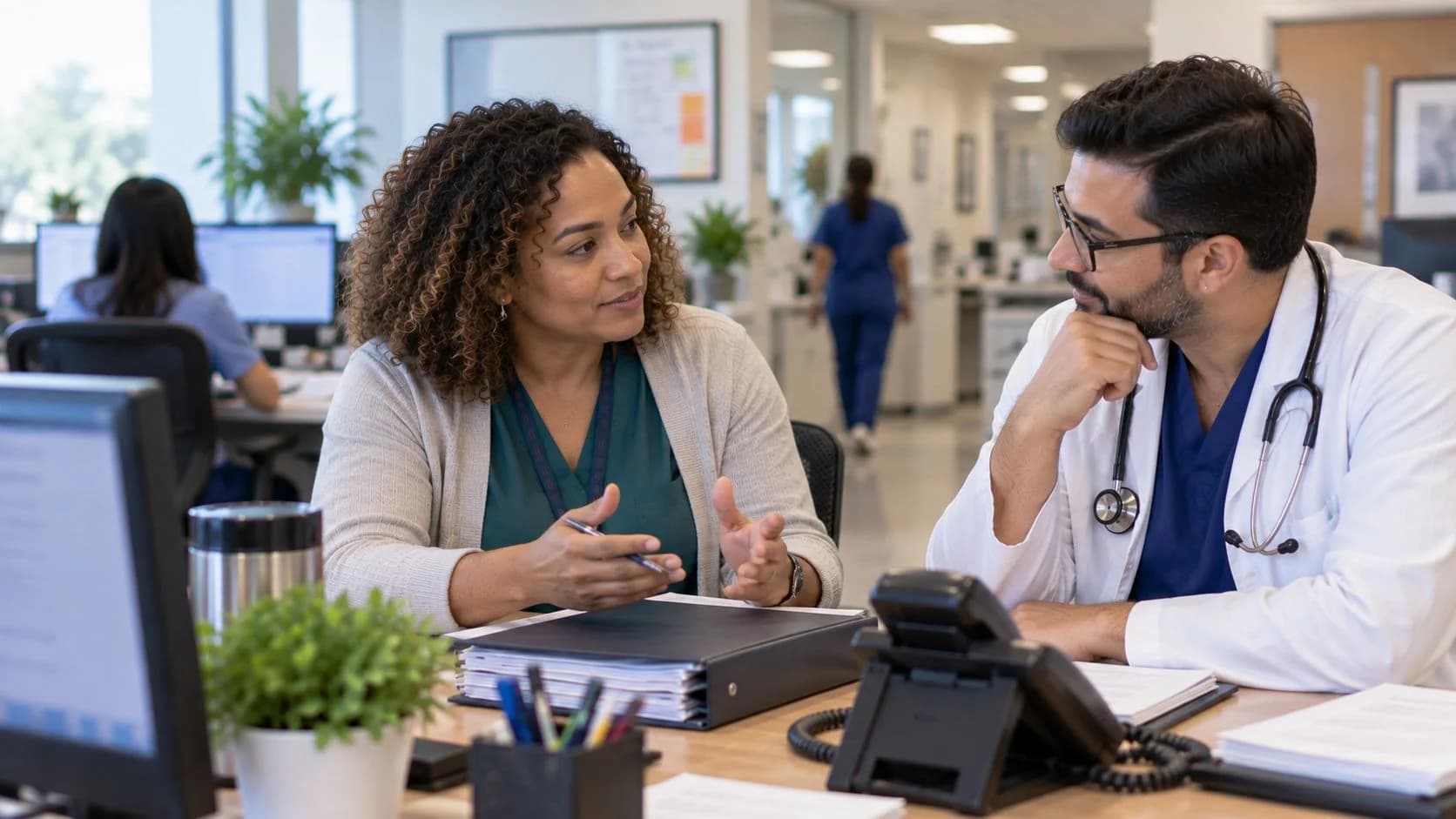 Medical coder and clinician resolving a claim detail together