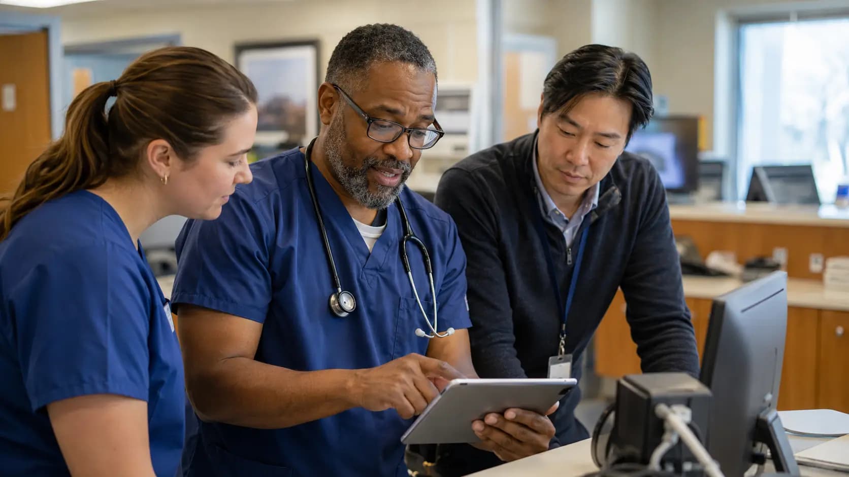 Clinician and informatics specialists collaborating at a normal workstation