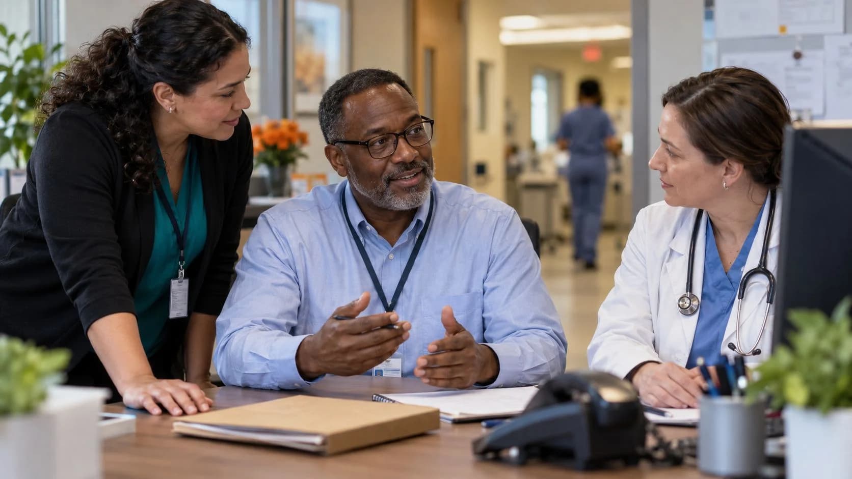 Denial-resolution specialist and clinician reviewing a claim together
