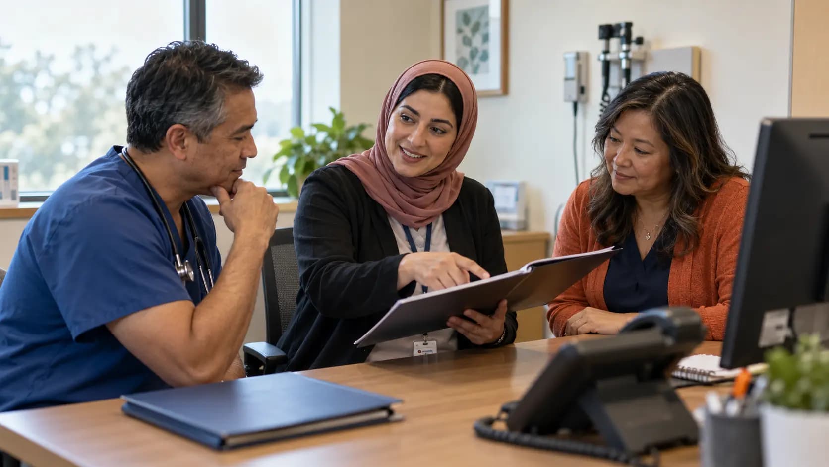 Practice manager and clinician reviewing payer requirements with a specialist