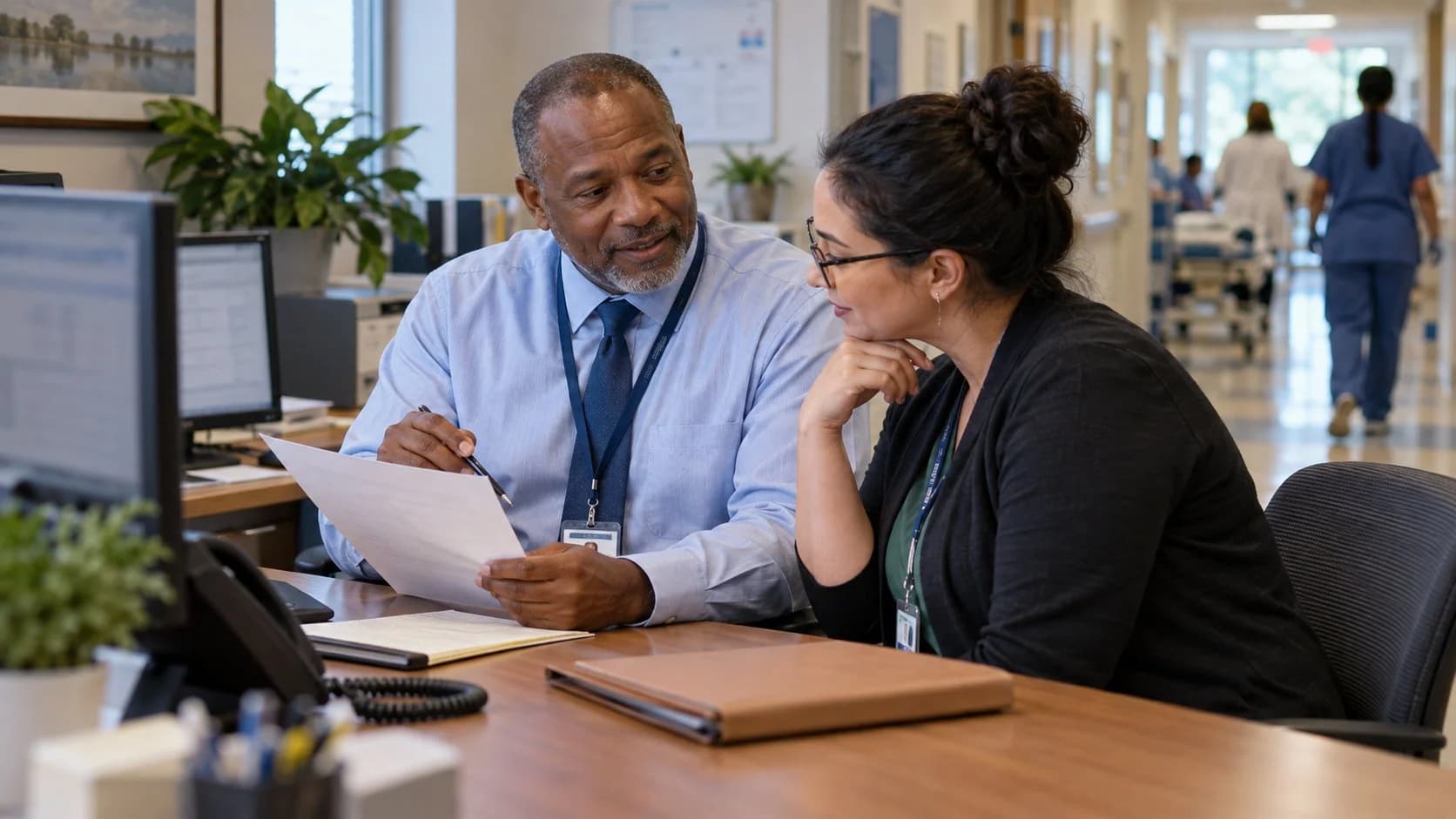 Reimbursement analyst and revenue manager reviewing a payment variance