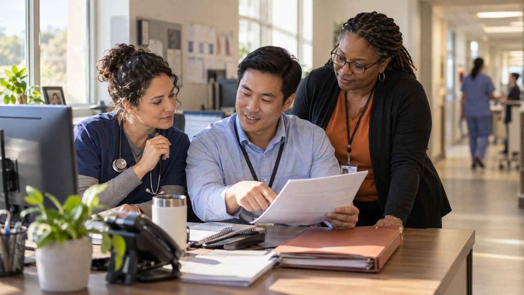 Denial-resolution specialist and clinician reviewing a claim together
