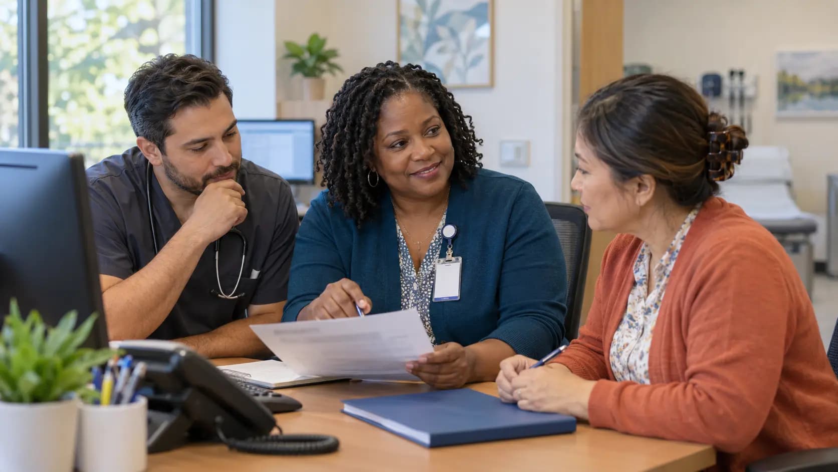 Practice manager and clinician reviewing payer requirements with a specialist