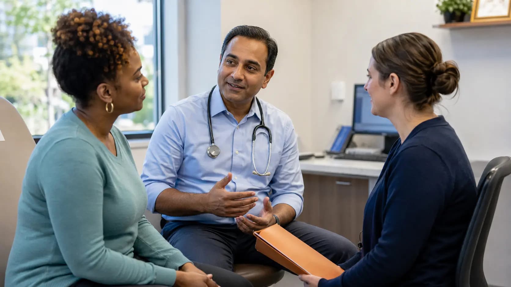 Clinician, patient, and healthcare colleague sharing a warm clinic interaction Clinician, patient, and healthcare colleague sharing a warm clinic interaction