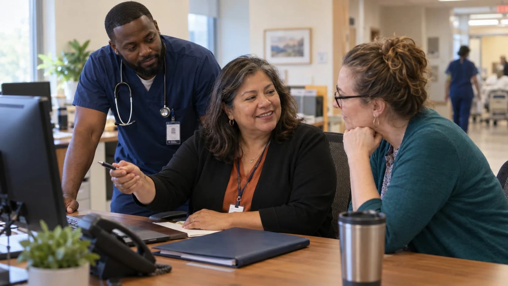 Denial-resolution specialist and clinician reviewing a claim together