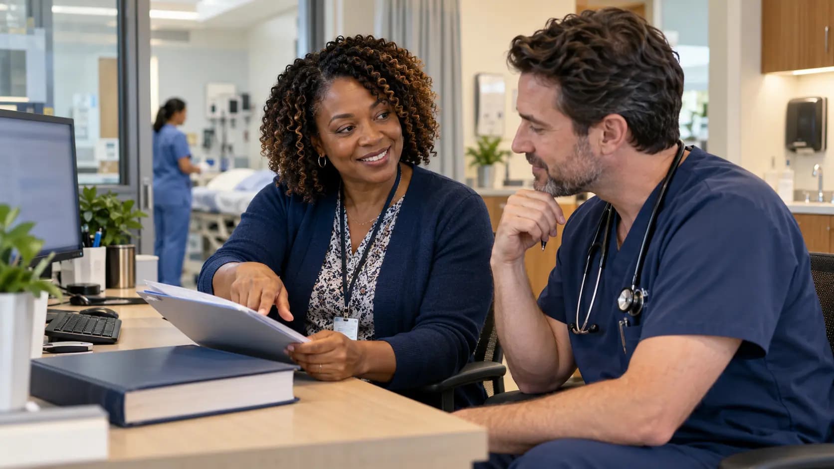 Medical coder and clinician resolving documentation together Medical coder and clinician resolving documentation together