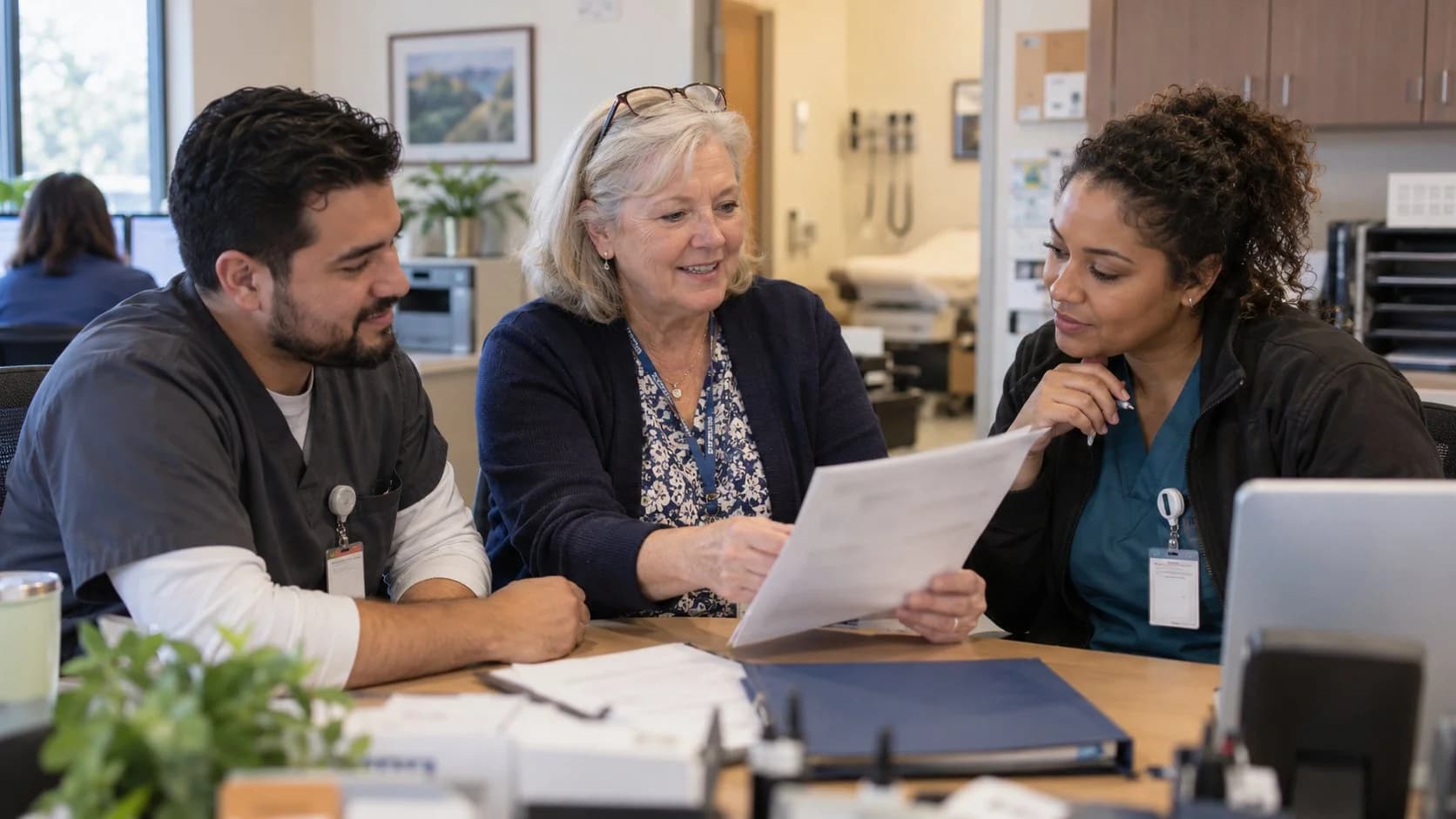 Revenue-cycle educator discussing a workflow with medical-office colleagues