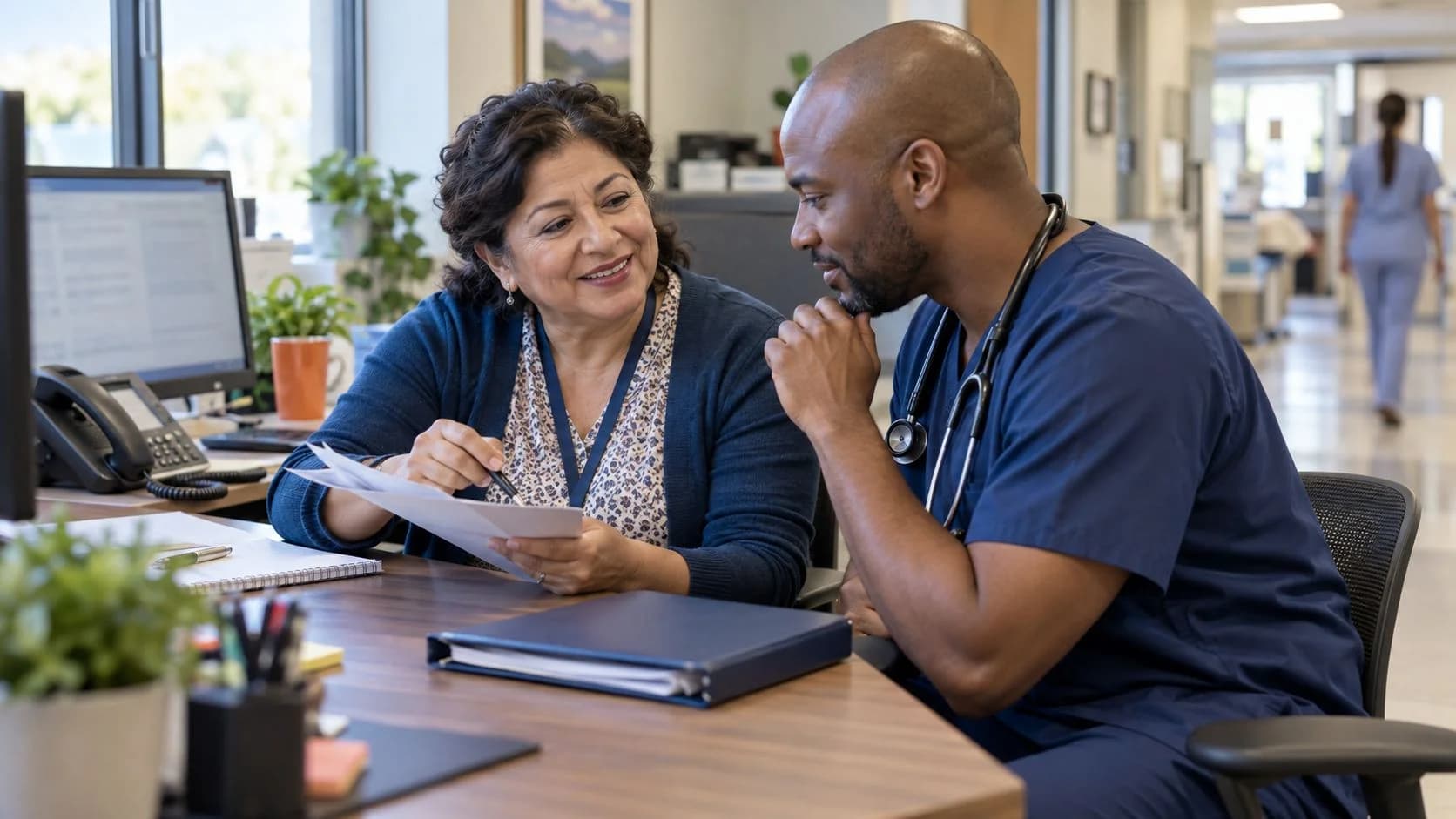 Medical coder and clinician resolving a claim detail together