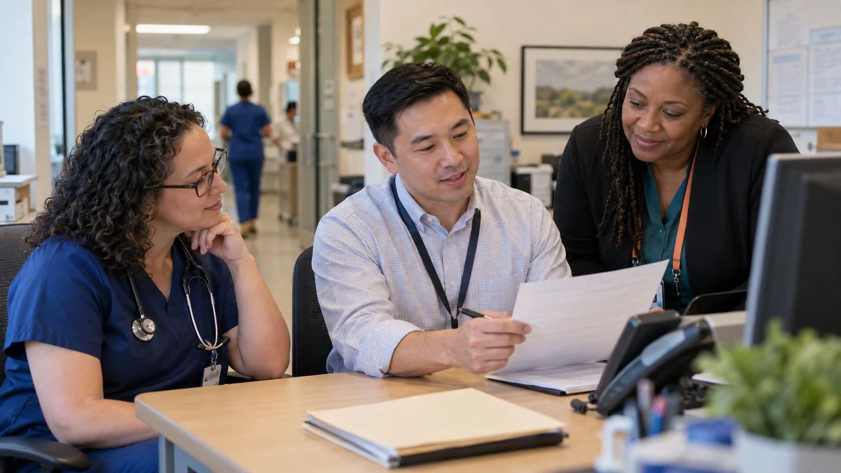 Denial-resolution specialist and clinician reviewing a claim together