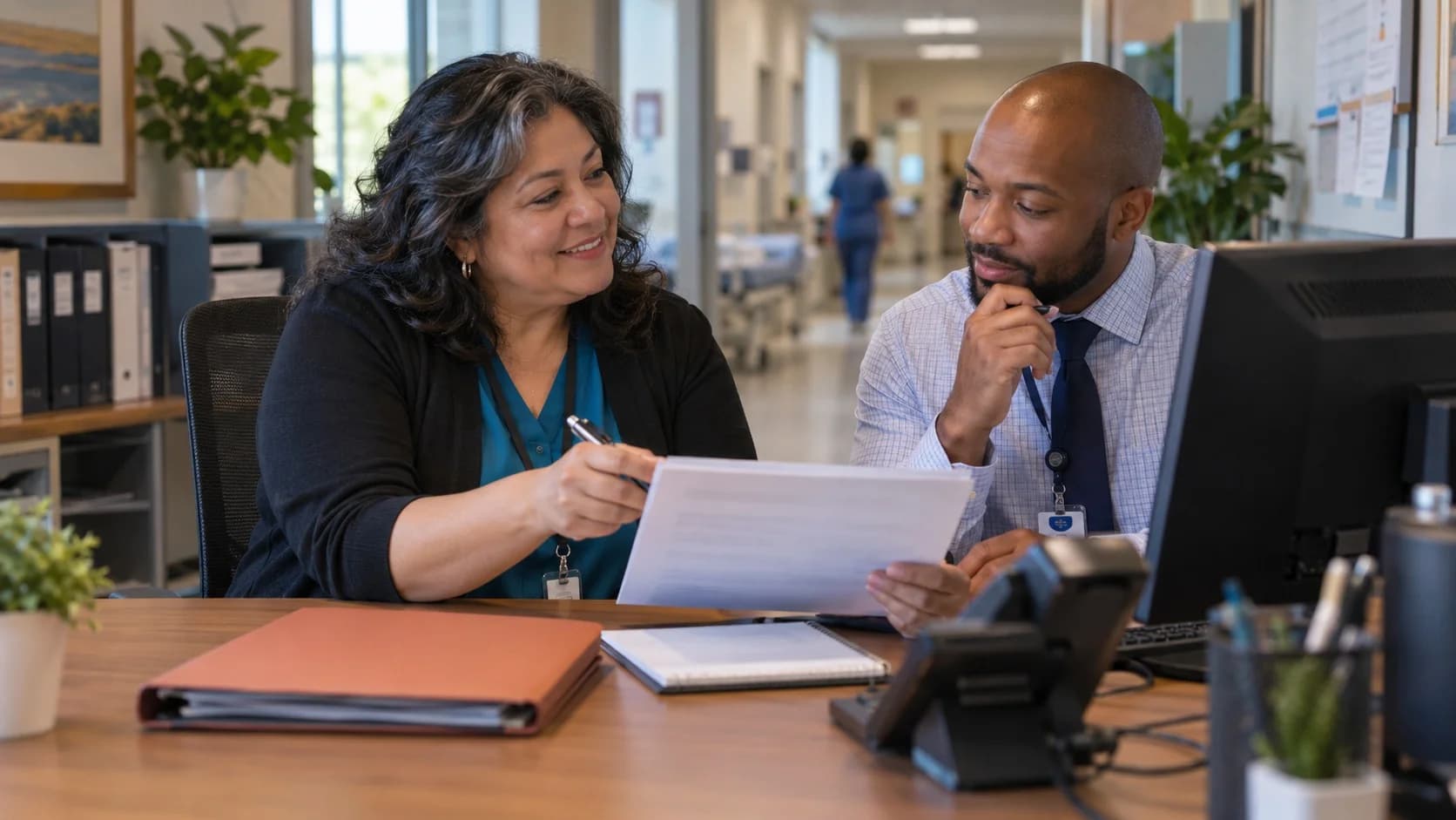 Reimbursement analyst and revenue manager reviewing a payment variance