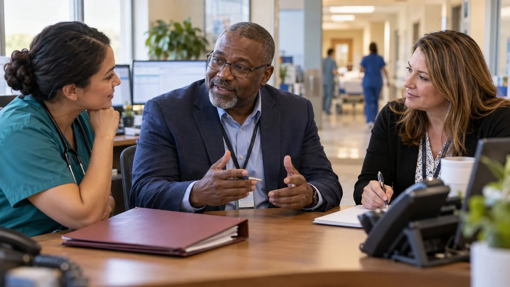 Denial-resolution specialist and clinician reviewing a claim together
