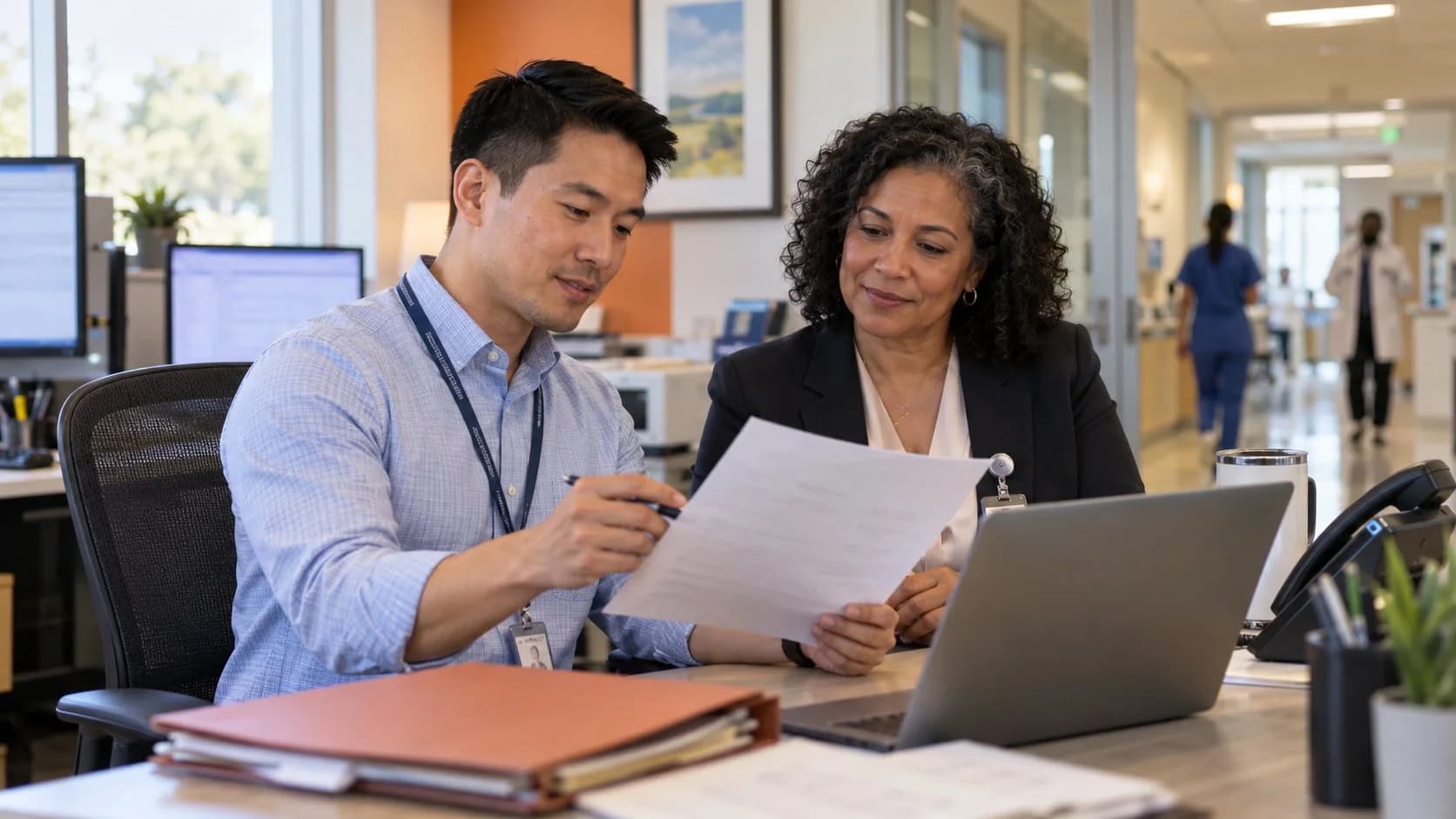 Reimbursement analyst and revenue manager reviewing a payment variance