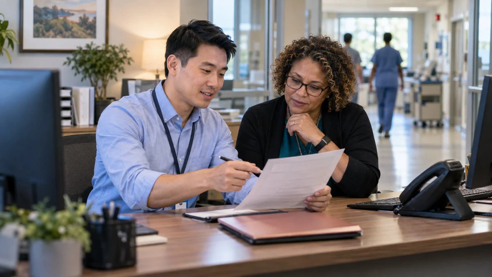 Reimbursement analyst and revenue manager reviewing a payment variance