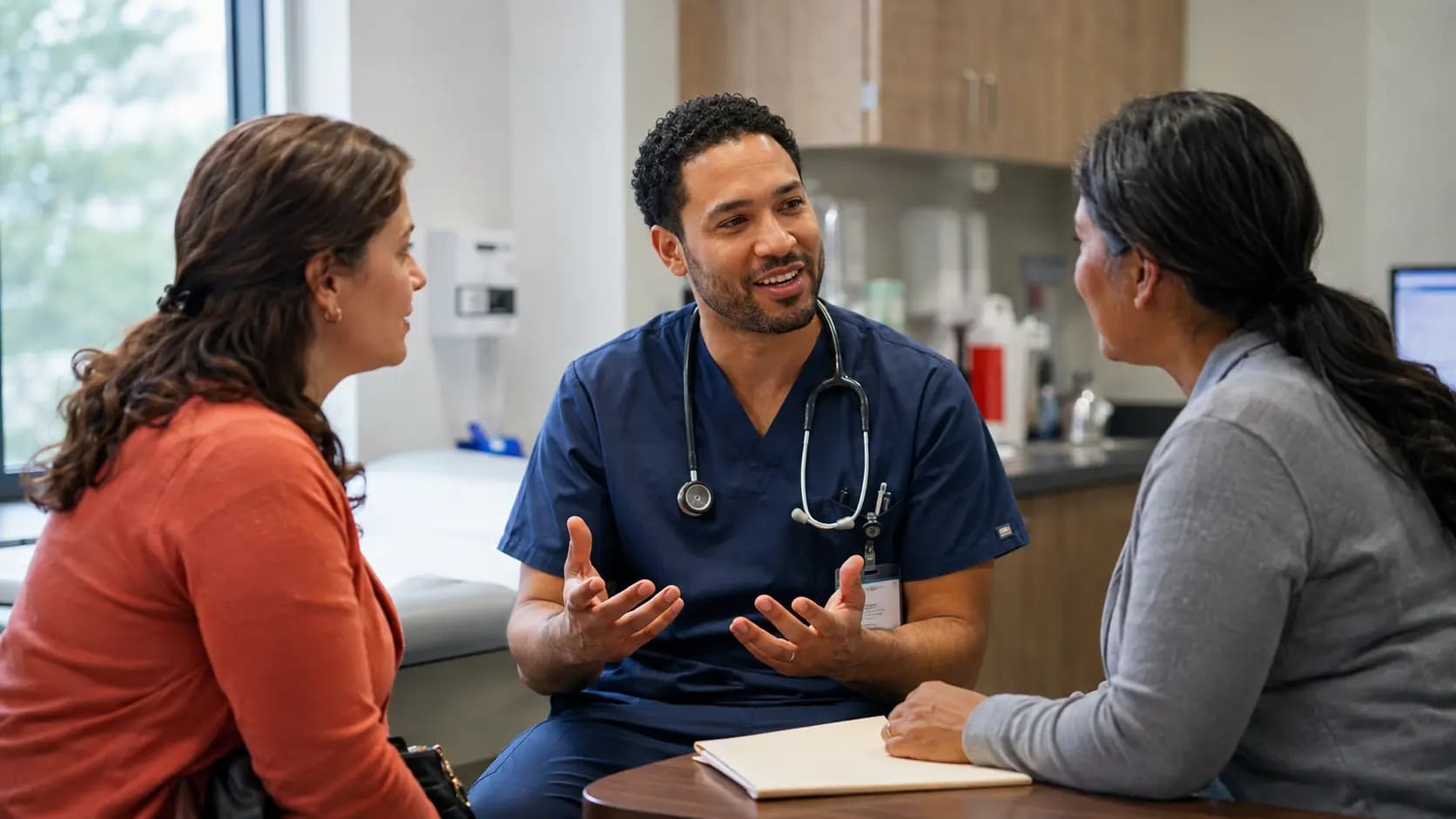 Clinician, patient, and healthcare colleague sharing a warm clinic interaction