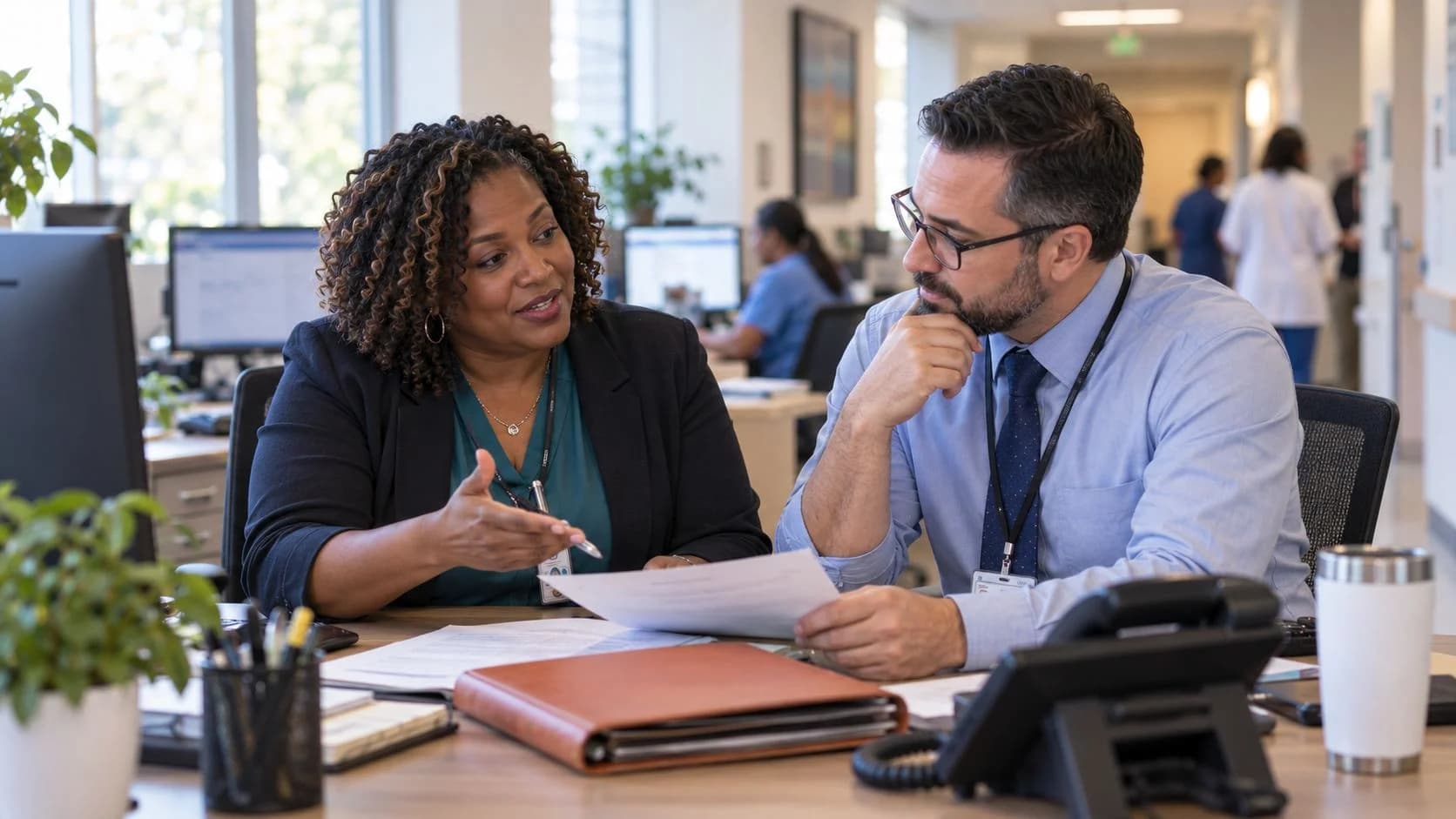 Reimbursement analyst and revenue manager reviewing a payment variance