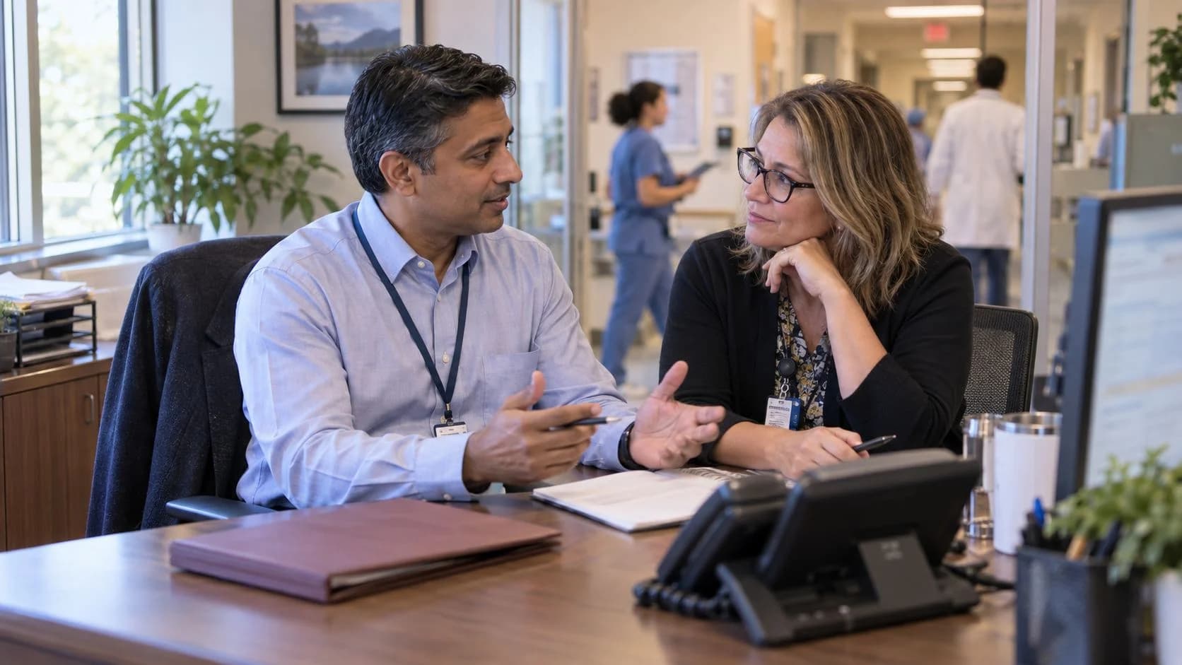 Reimbursement analyst and revenue manager reviewing a payment variance