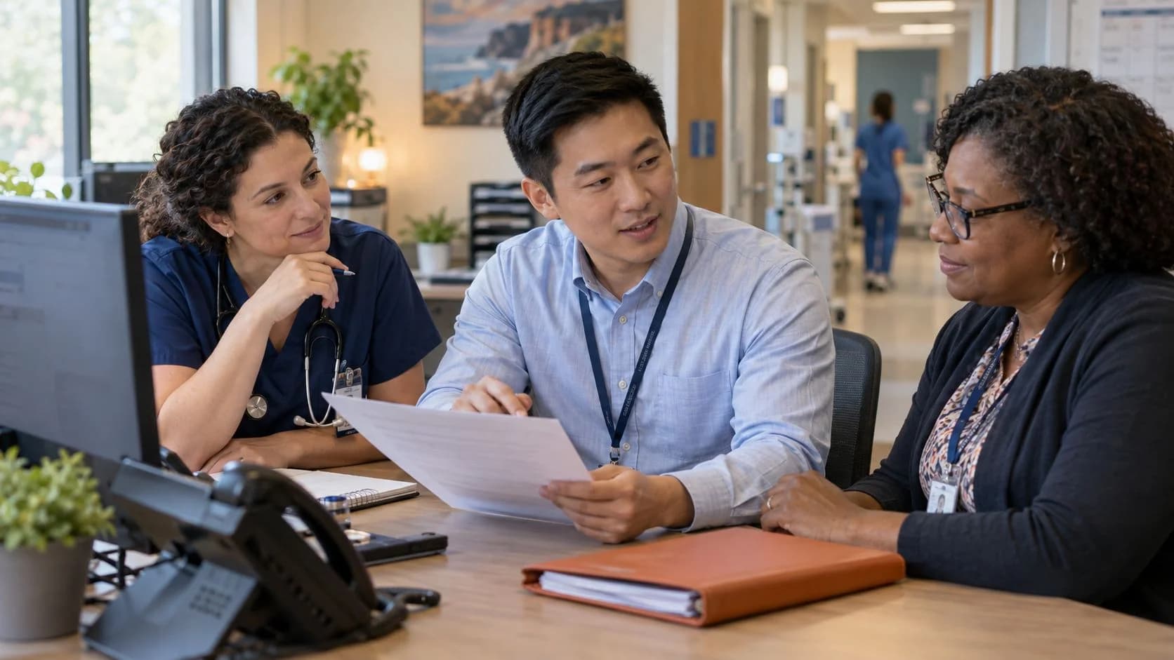 Denial-resolution specialist and clinician reviewing a claim together