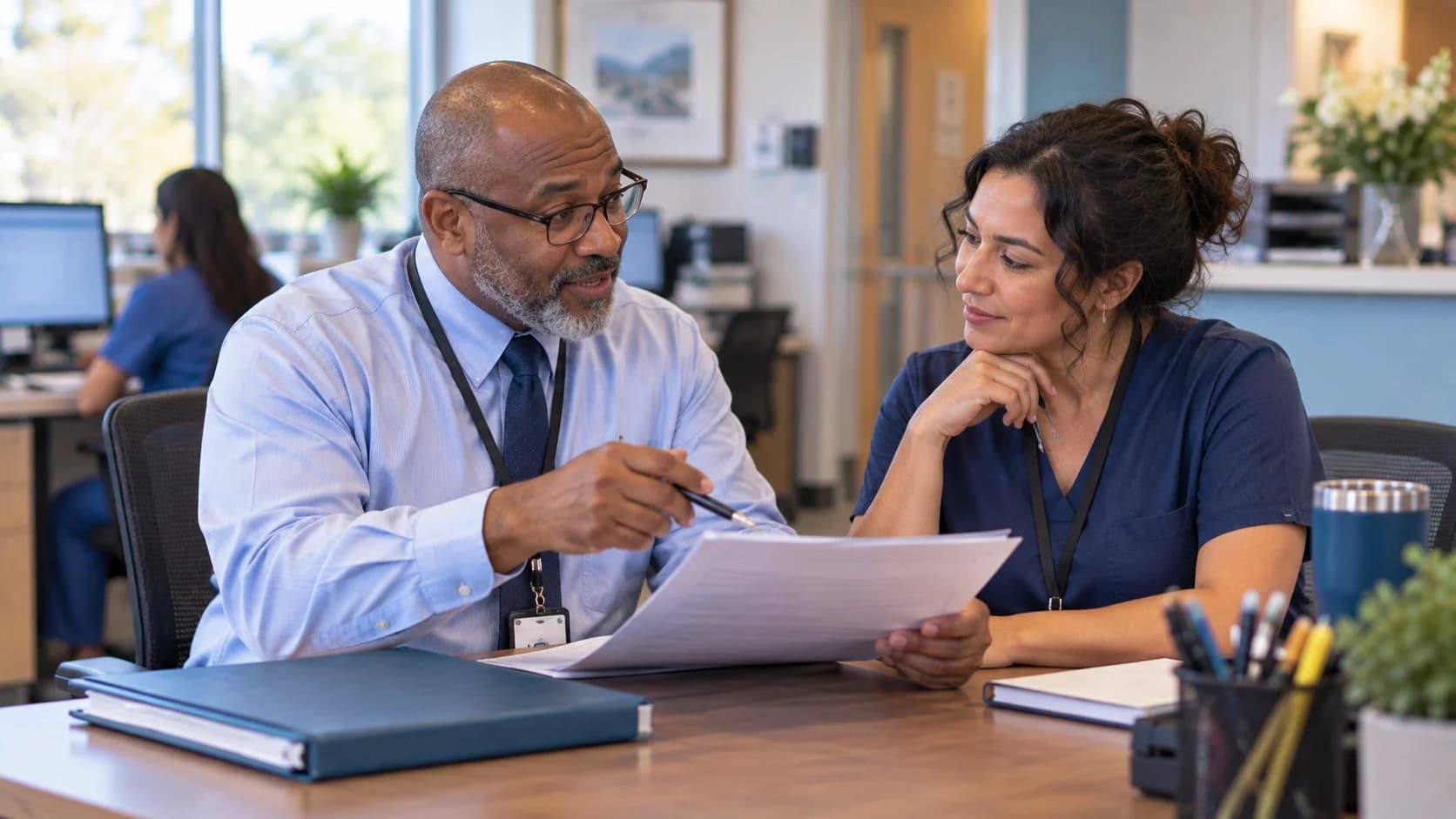 Healthcare compliance officer reviewing a safe workflow with clinic staff