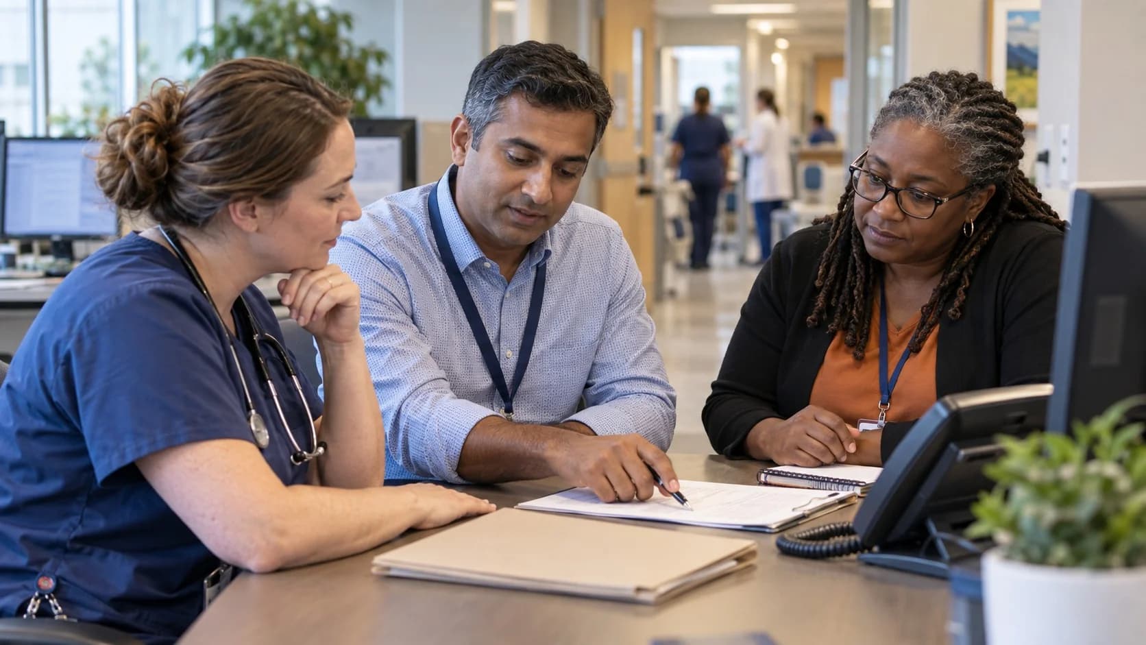 Denial-resolution specialist and clinician reviewing a claim together