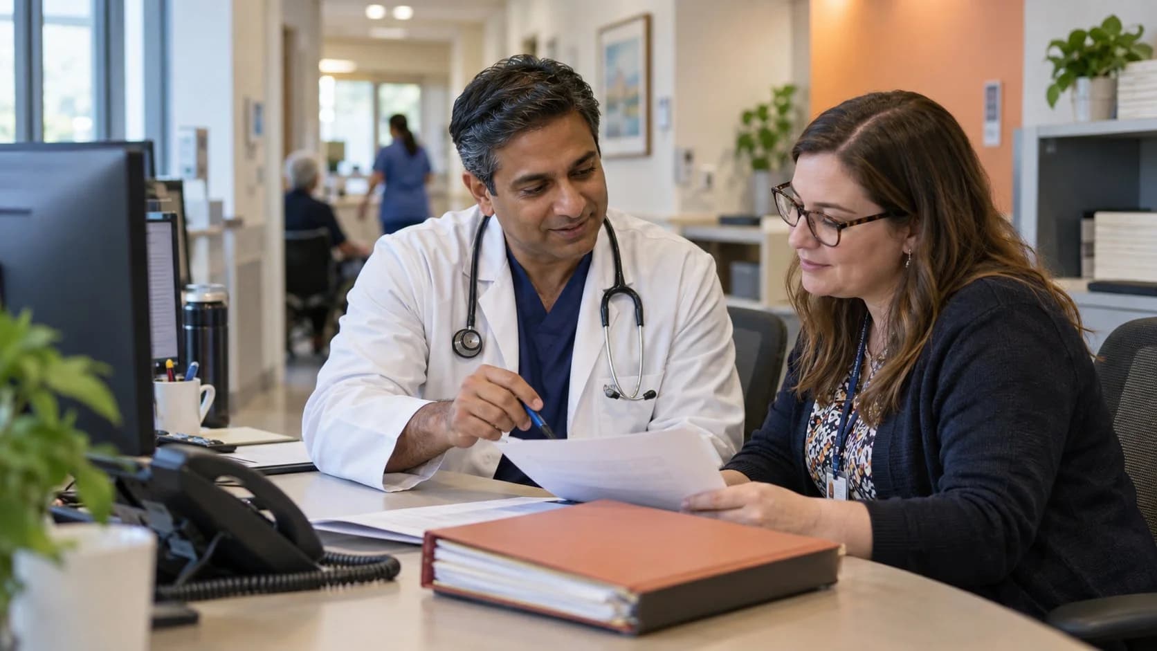 Medical coder and clinician resolving a claim detail together