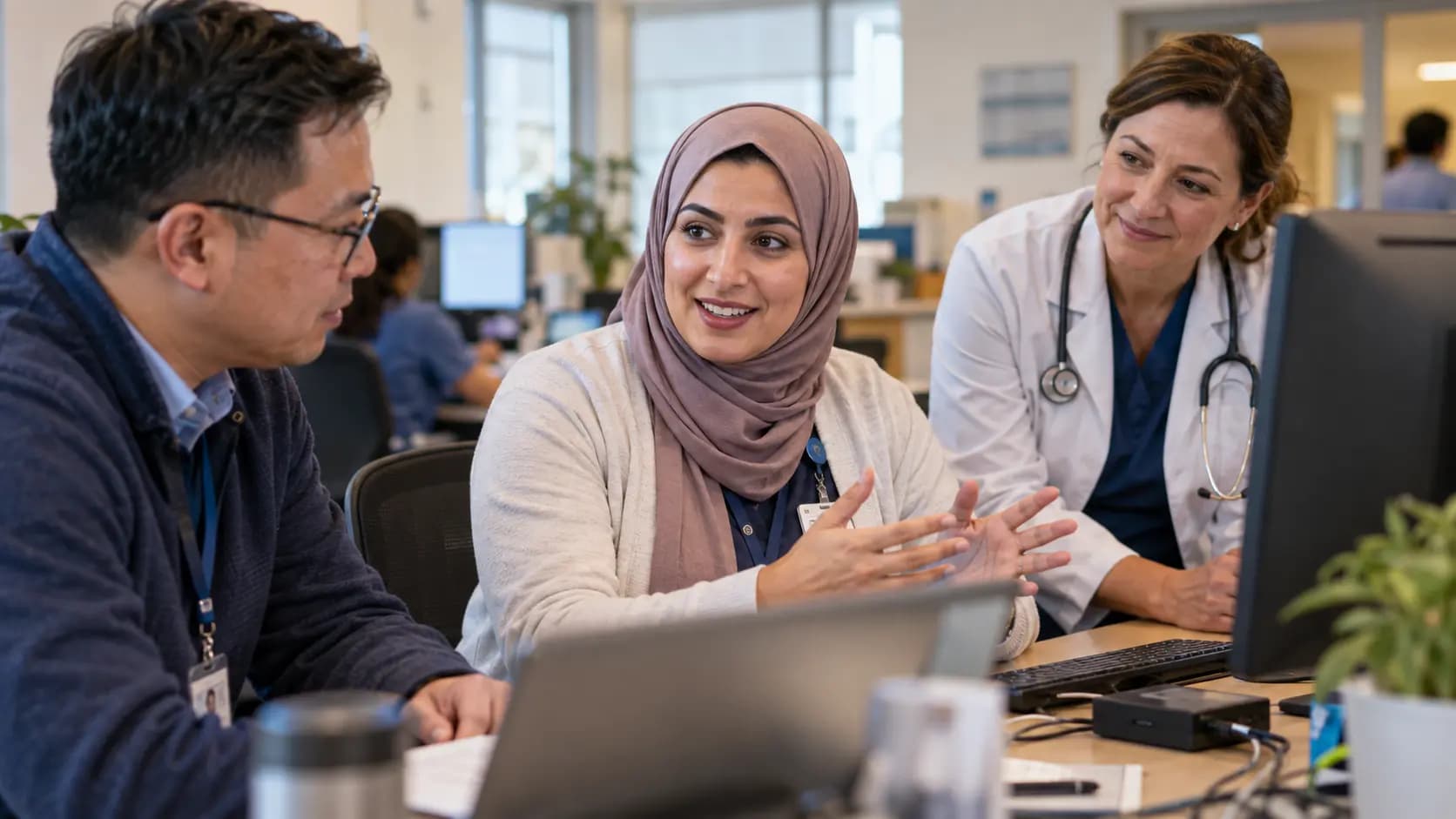Clinician and informatics specialists collaborating at a normal workstation