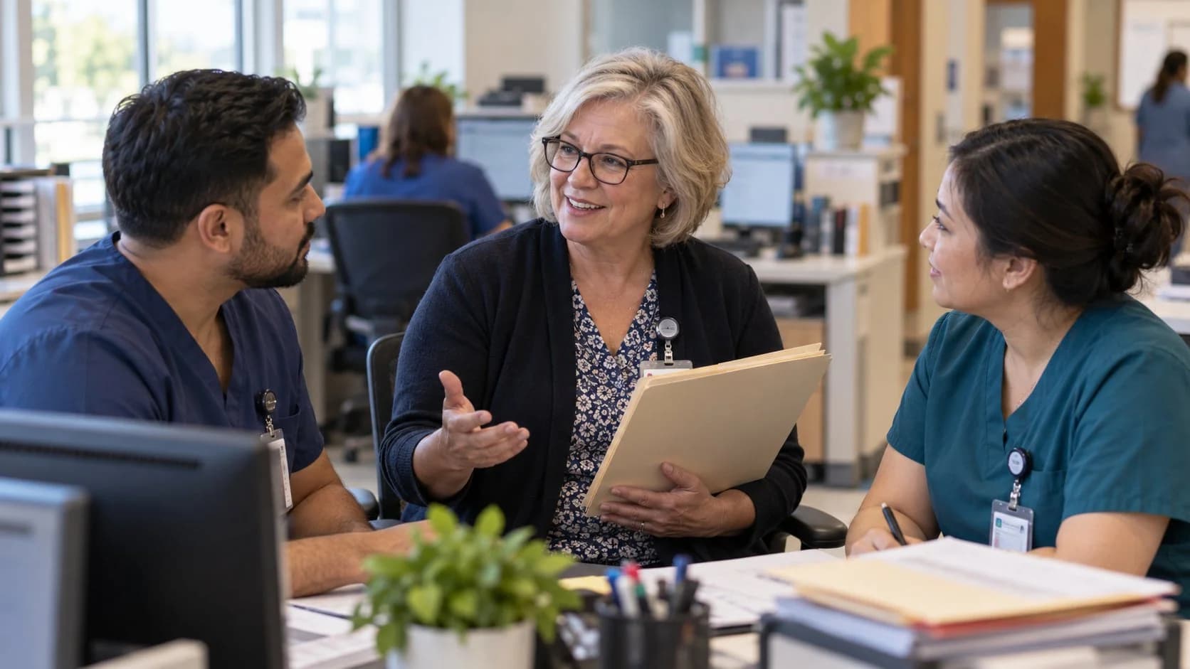 Revenue-cycle educator discussing a workflow with medical-office colleagues