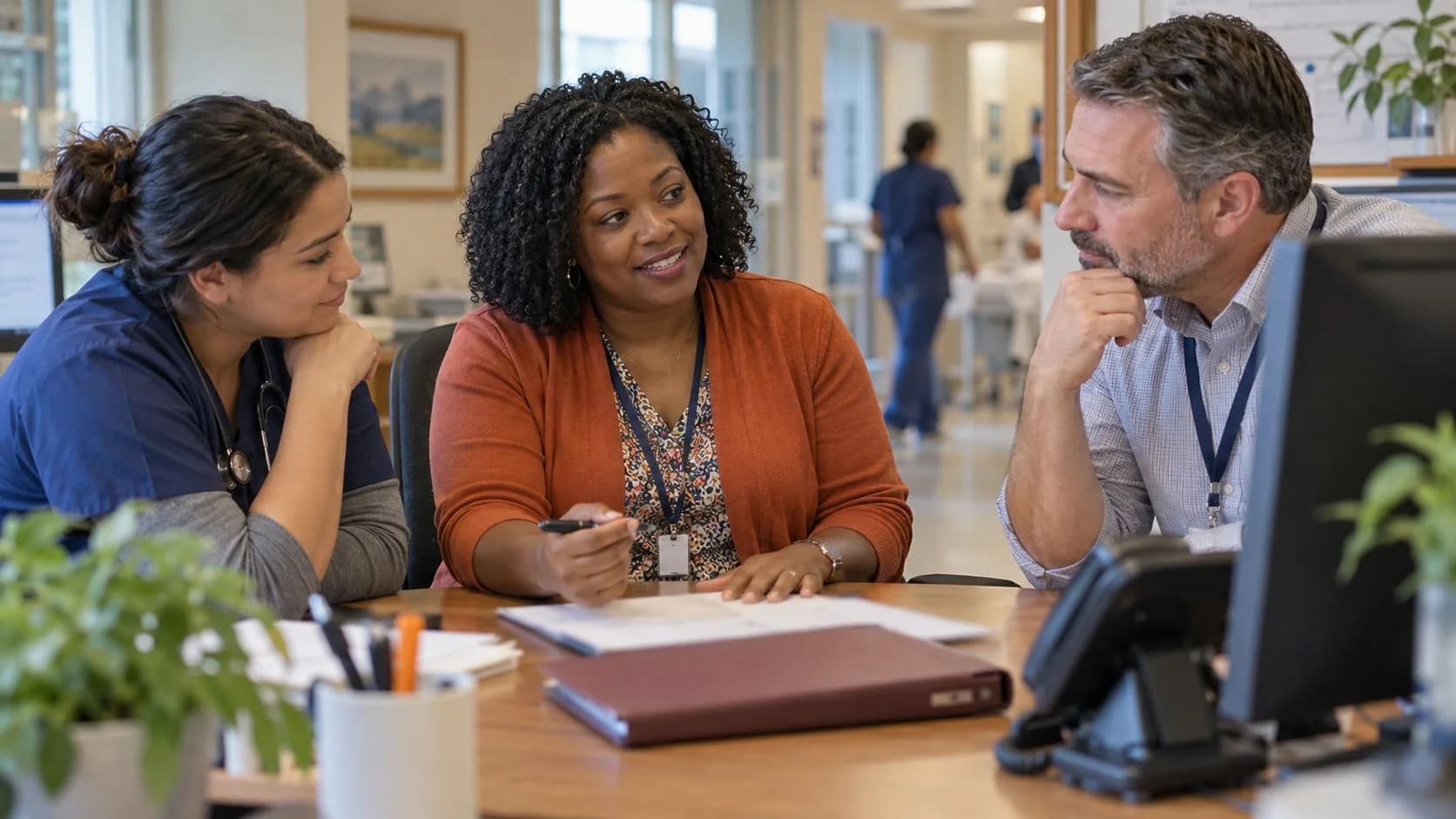 Denial-resolution specialist and clinician reviewing a claim together