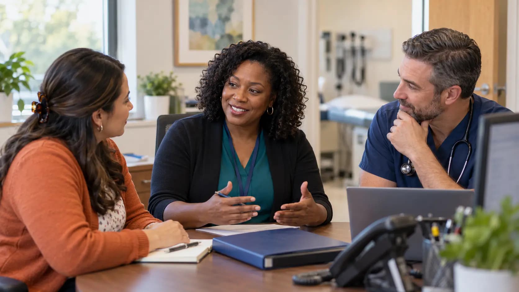 Practice manager and clinician reviewing payer requirements with a specialist