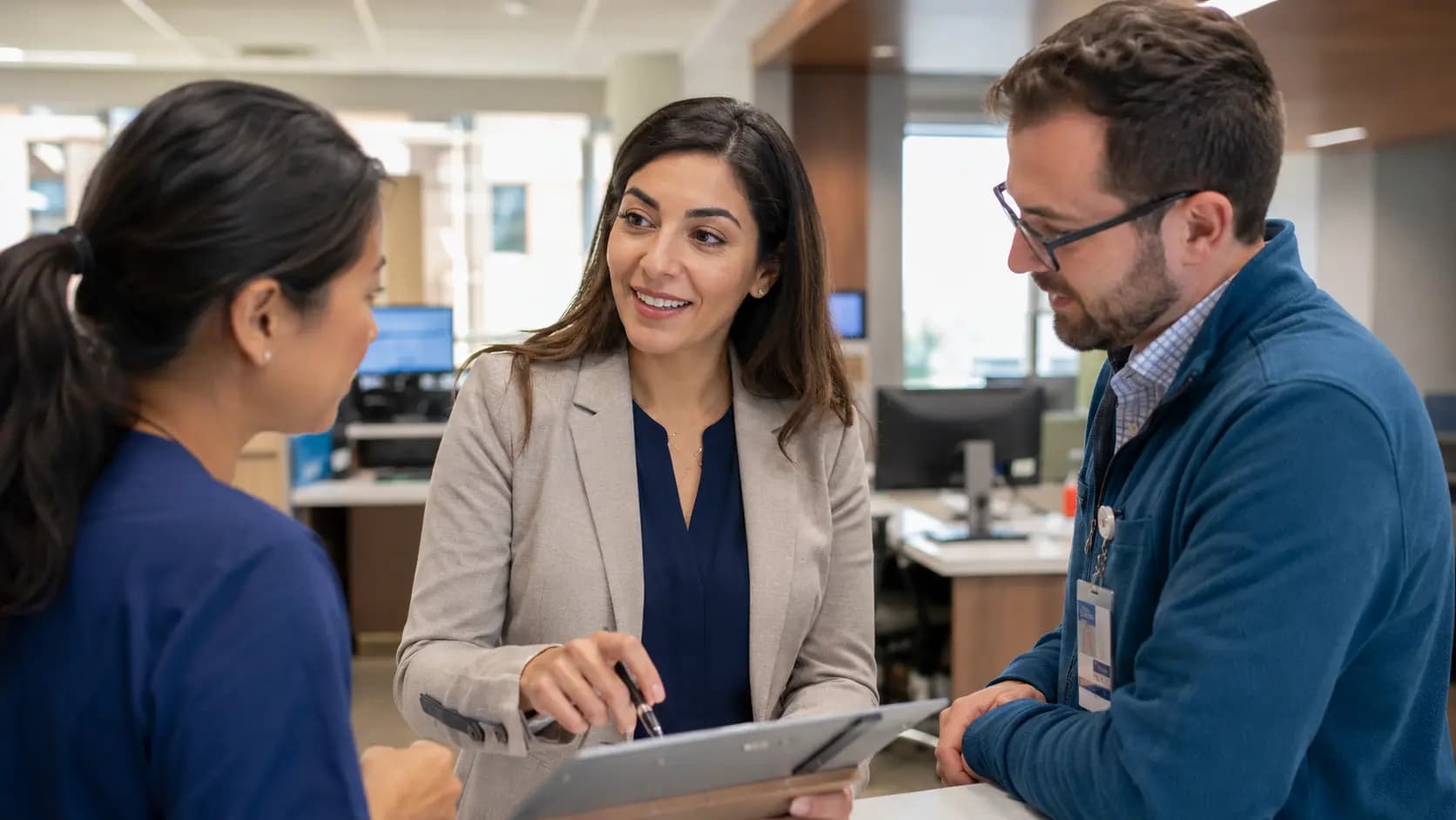 Clinician and informatics specialists collaborating at a normal workstation